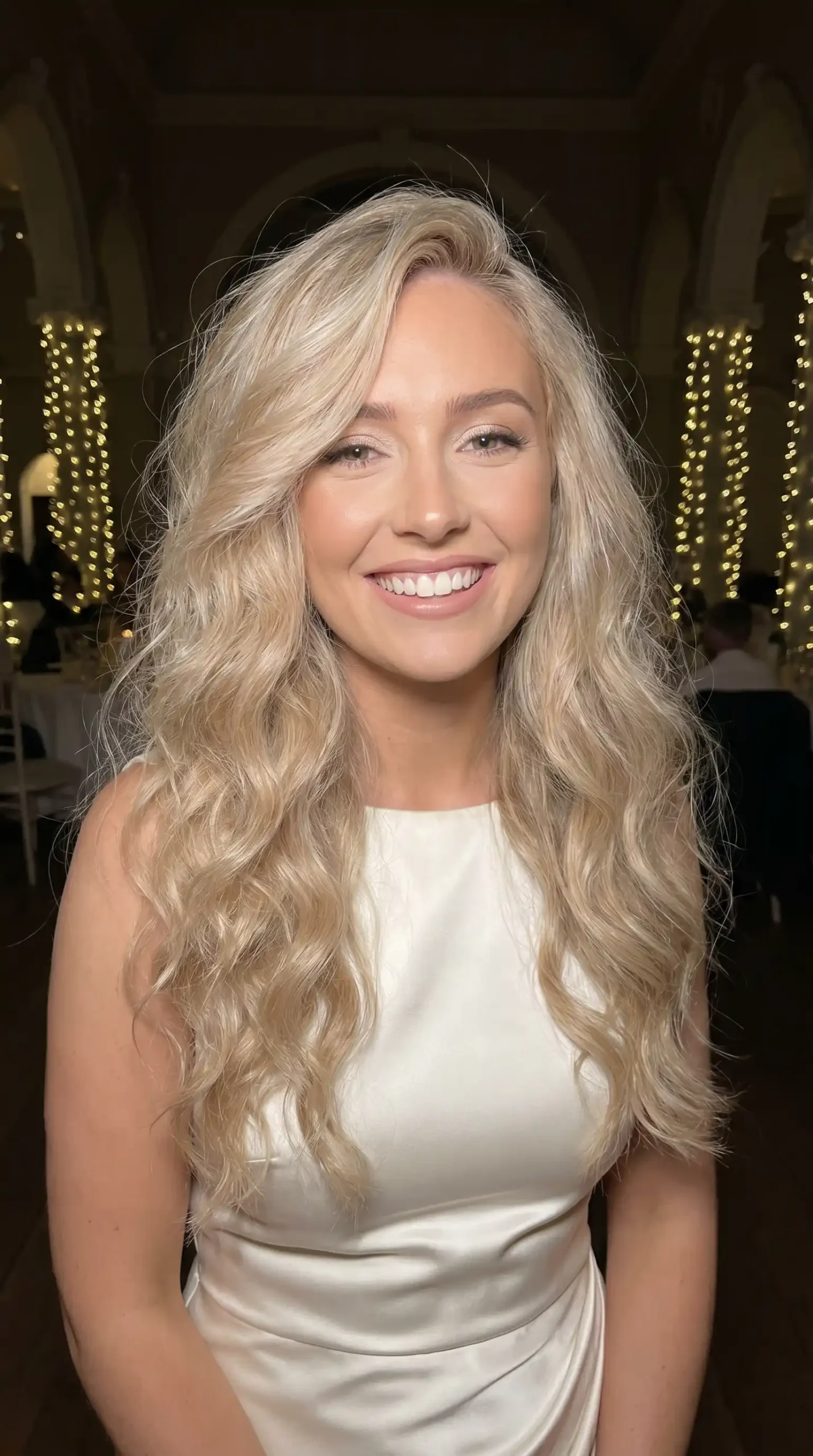 Woman with long champagne blonde tousled wave blowout hair