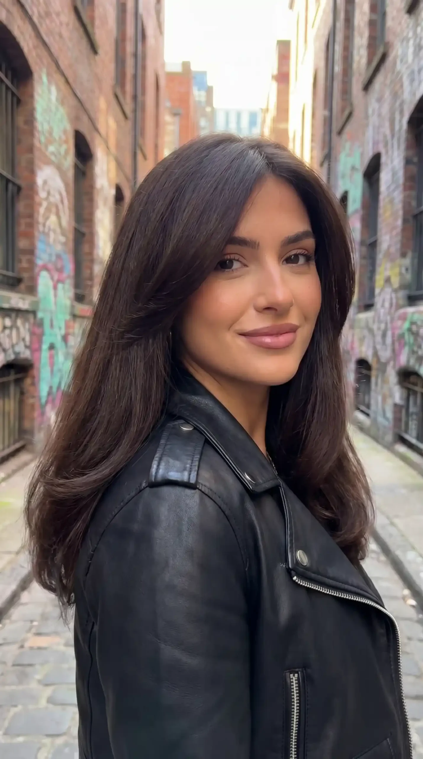 Woman with long espresso brown sleek straight blowout