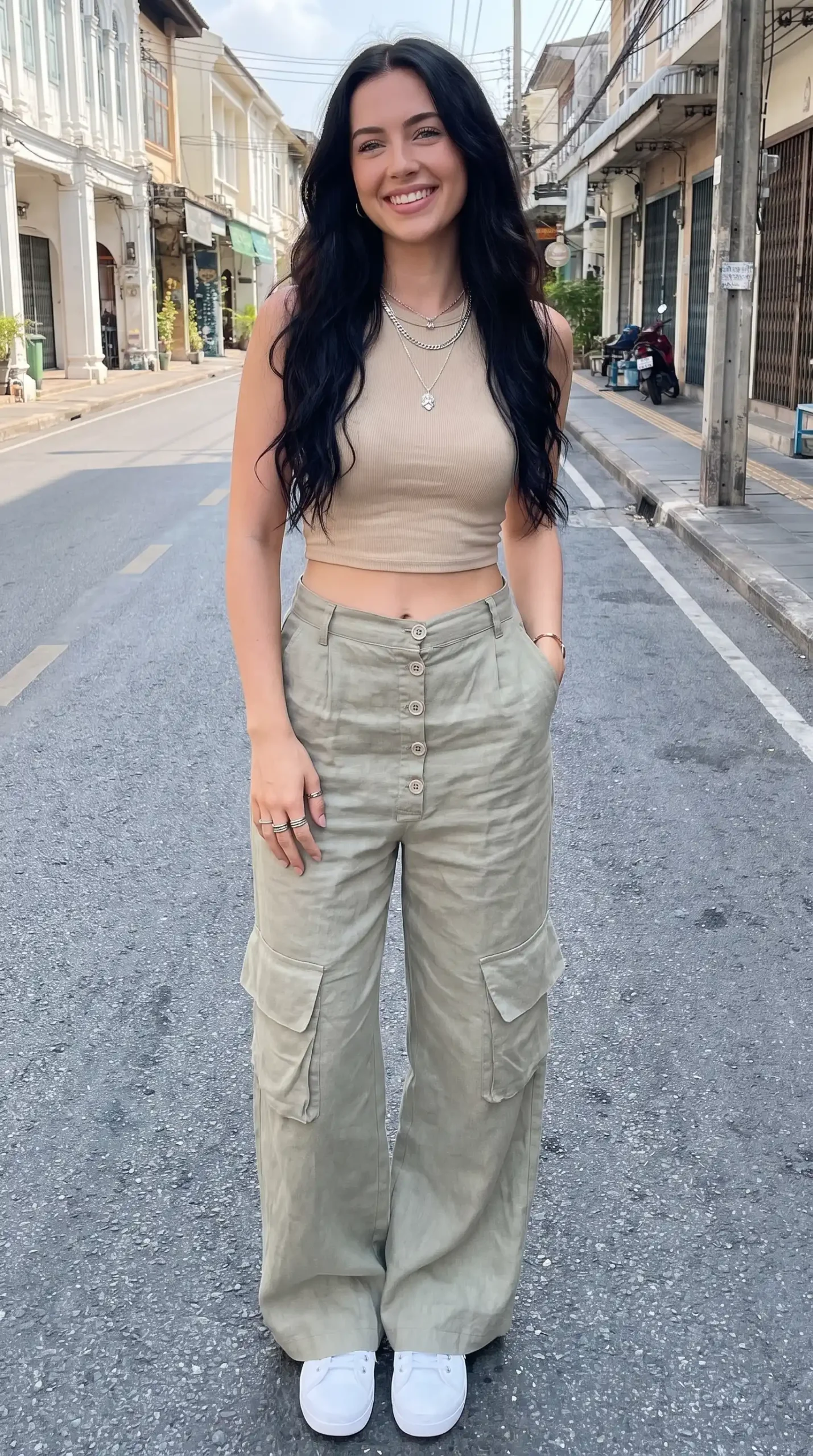 Woman wearing beige ribbed crop tank top with sage green linen cargo wide-leg pants outdoors