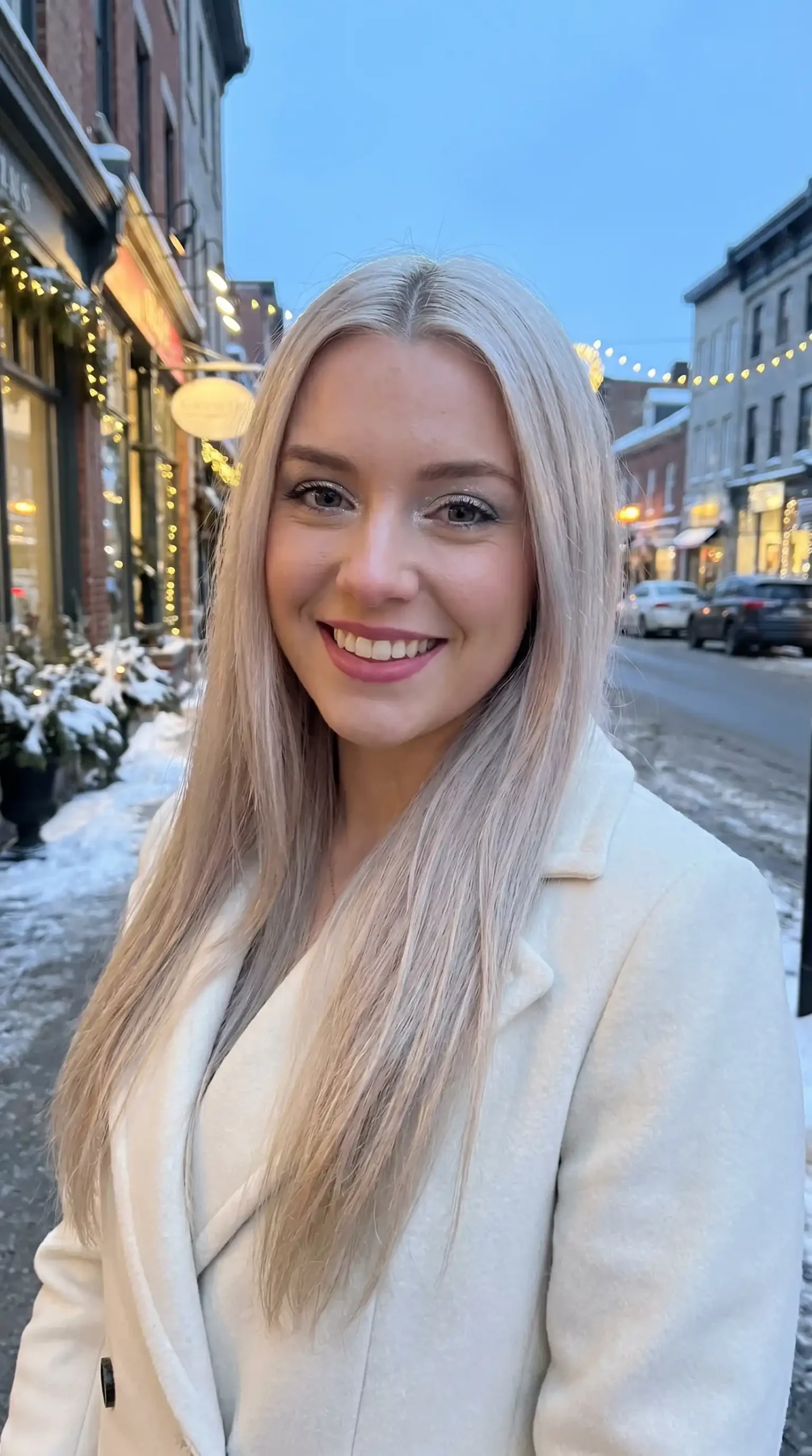 Woman with long icy blonde sleek straight blowout hair
