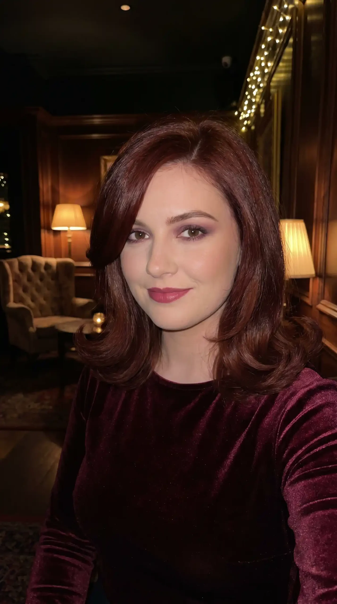 Woman with medium mahogany red flipped ends blowout hair