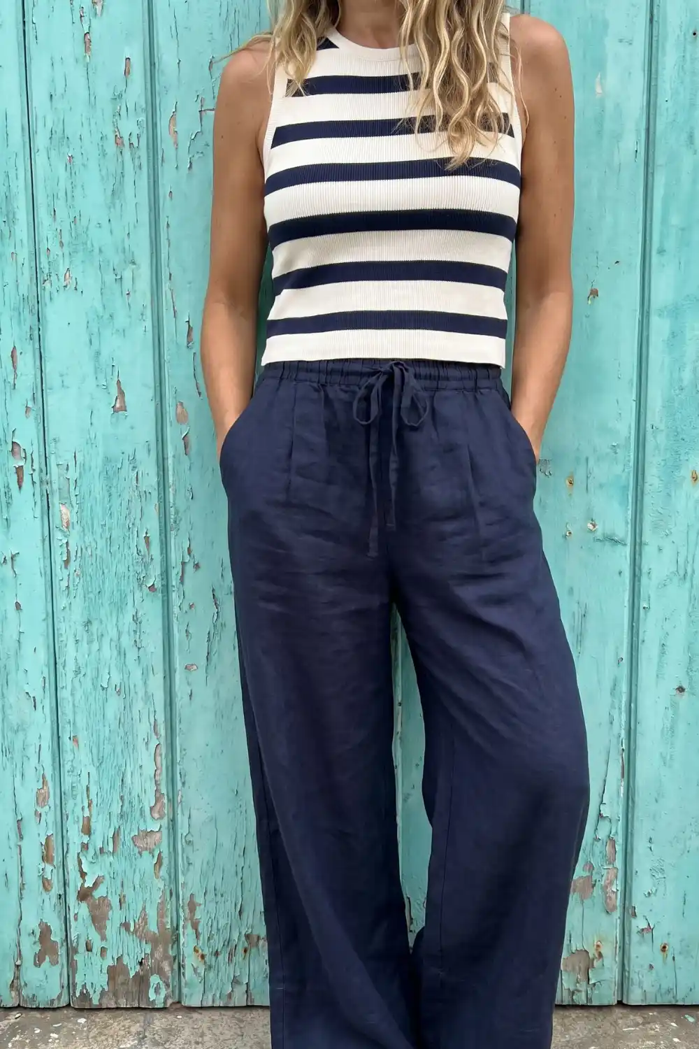 Woman in navy white stripe ribbed crop top with navy linen drawstring wide leg pants
