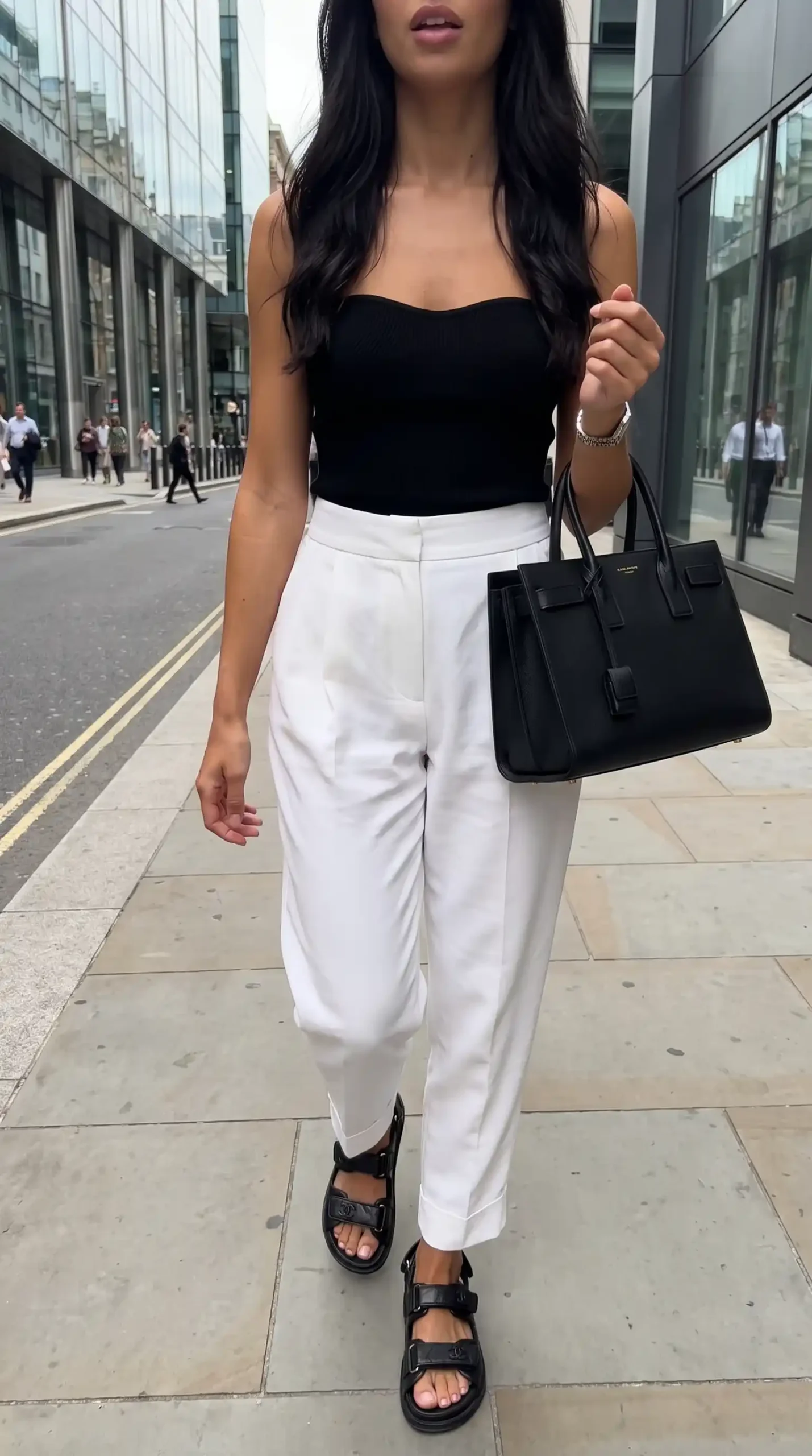 Black knit bandeau top with white wide leg trousers and black chunky sandals street style outfit
