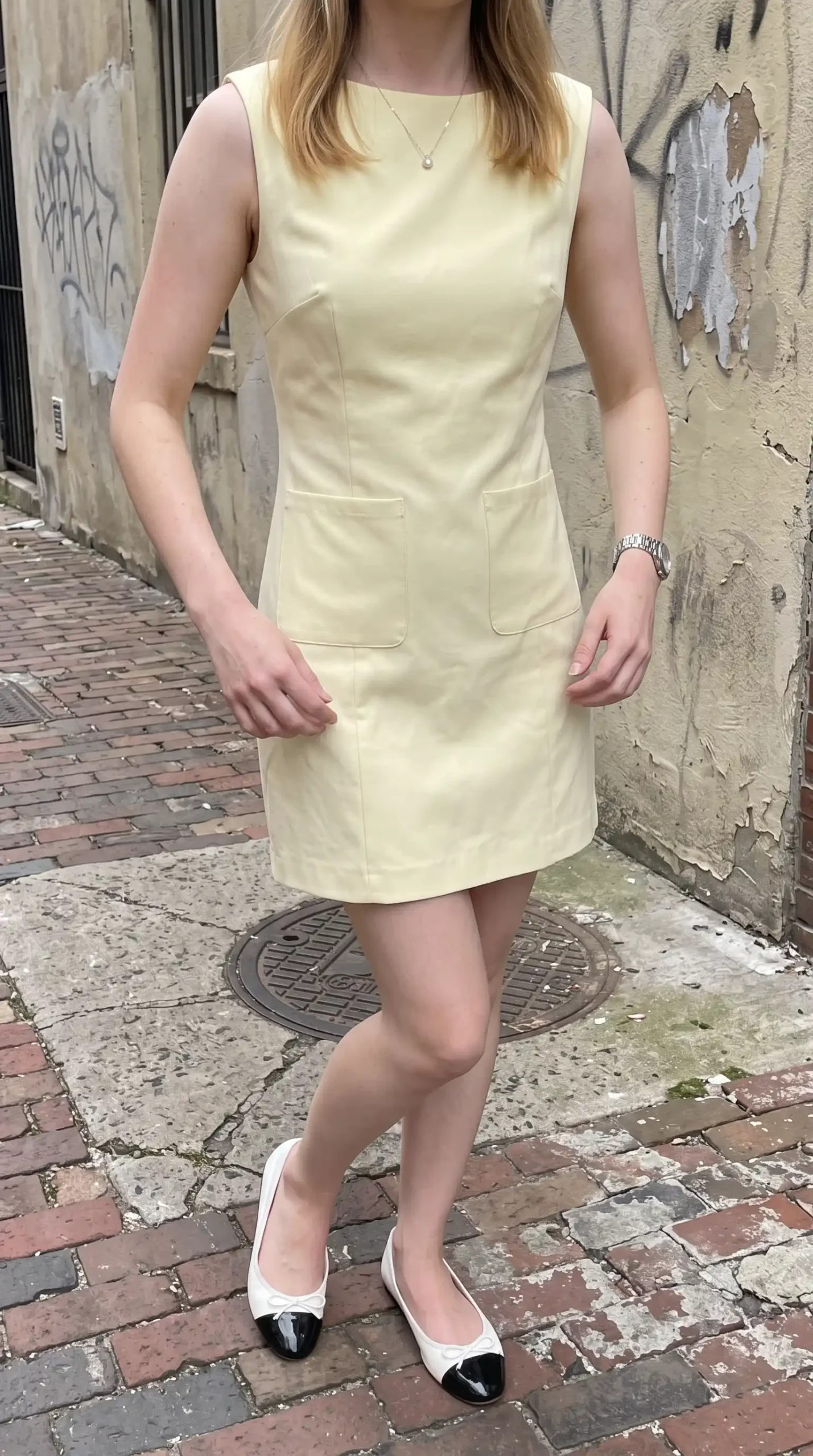 Butter yellow sleeveless patch pocket mini shift dress on city street spring
