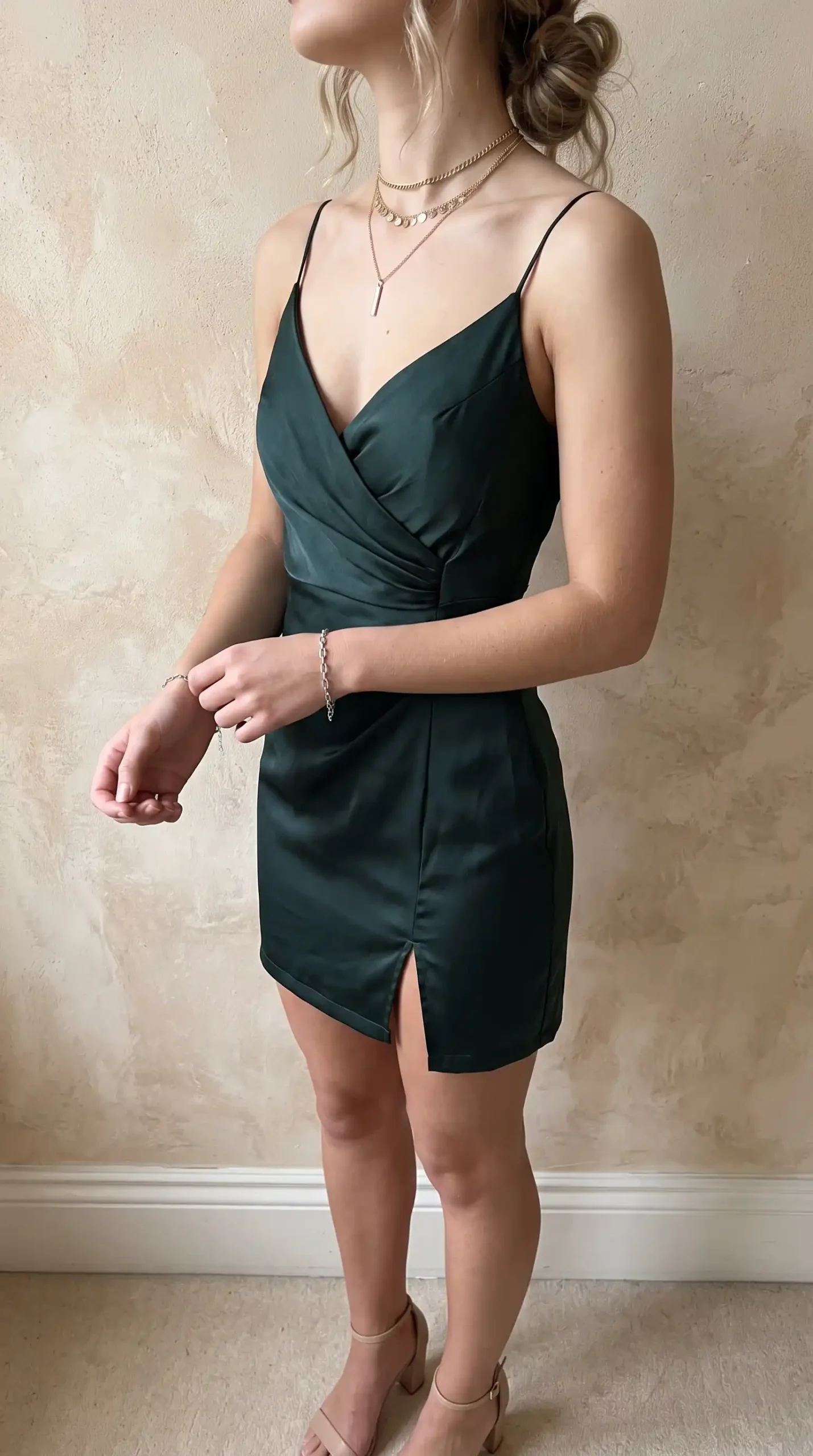 Forest green satin spaghetti strap wrap mini dress with front slit indoors
