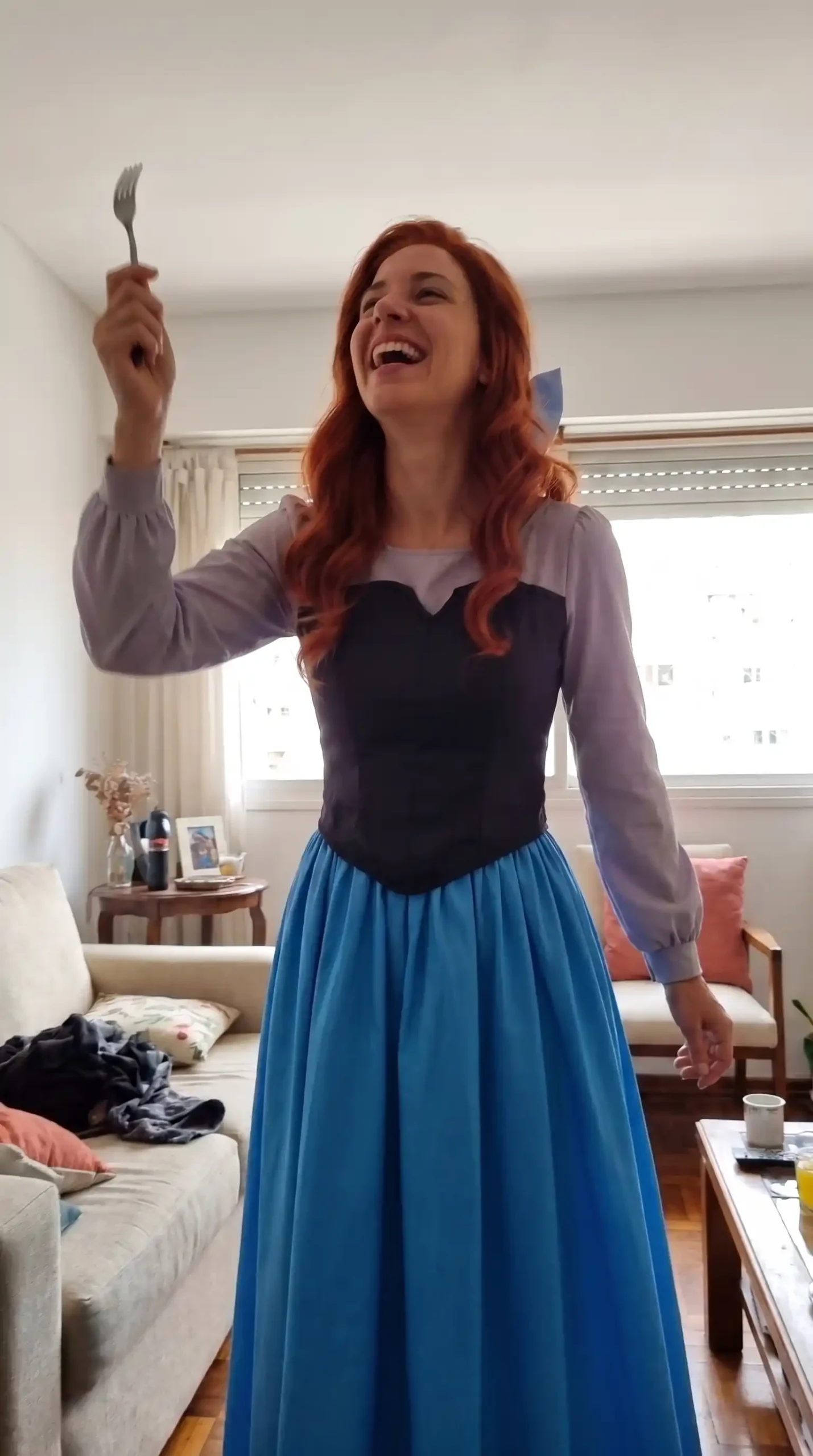 Woman dressed as Ariel from The Little Mermaid in human form costume