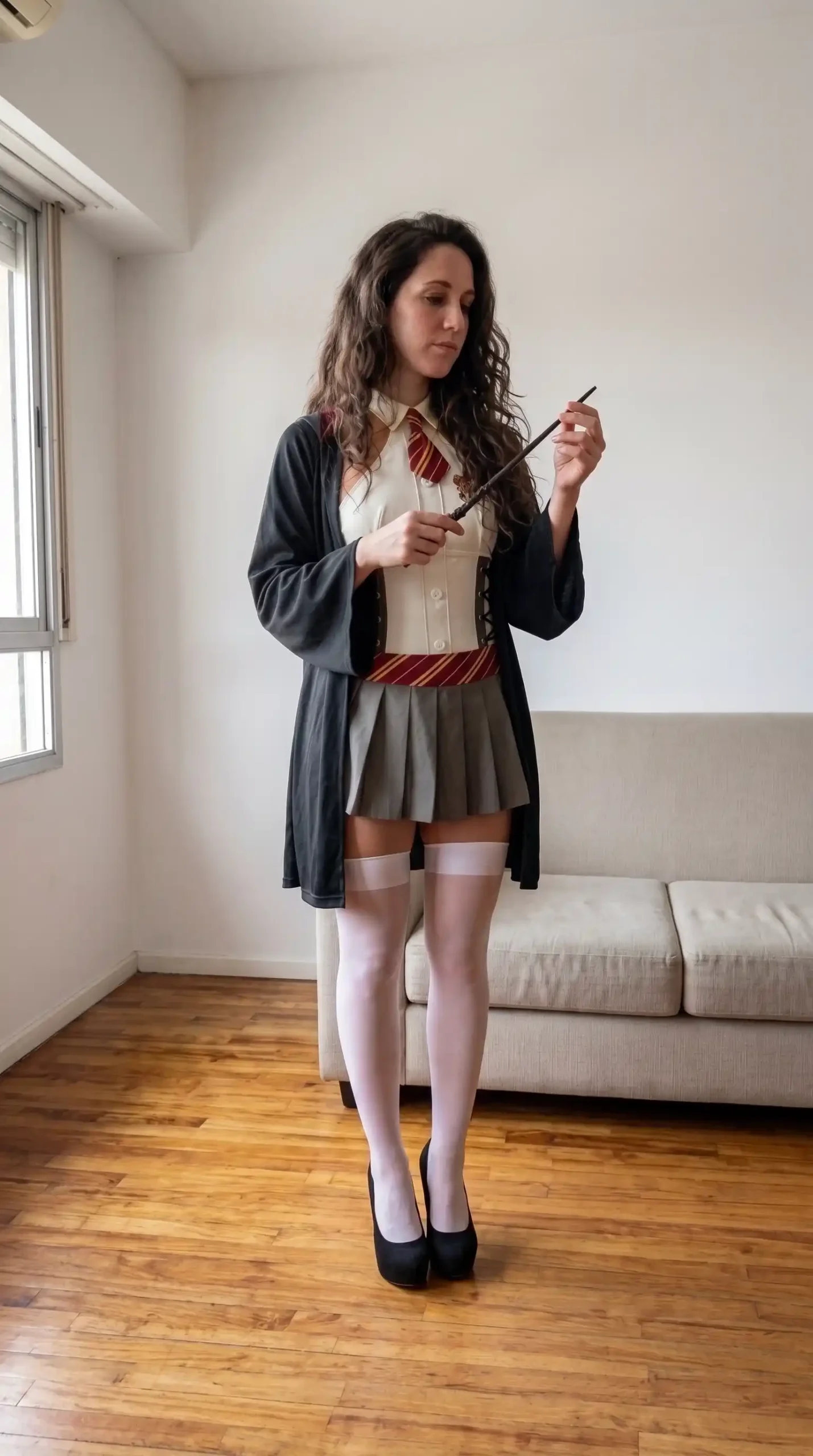 Woman dressed as Hermione Granger from Harry Potter in cream corset waistcoat