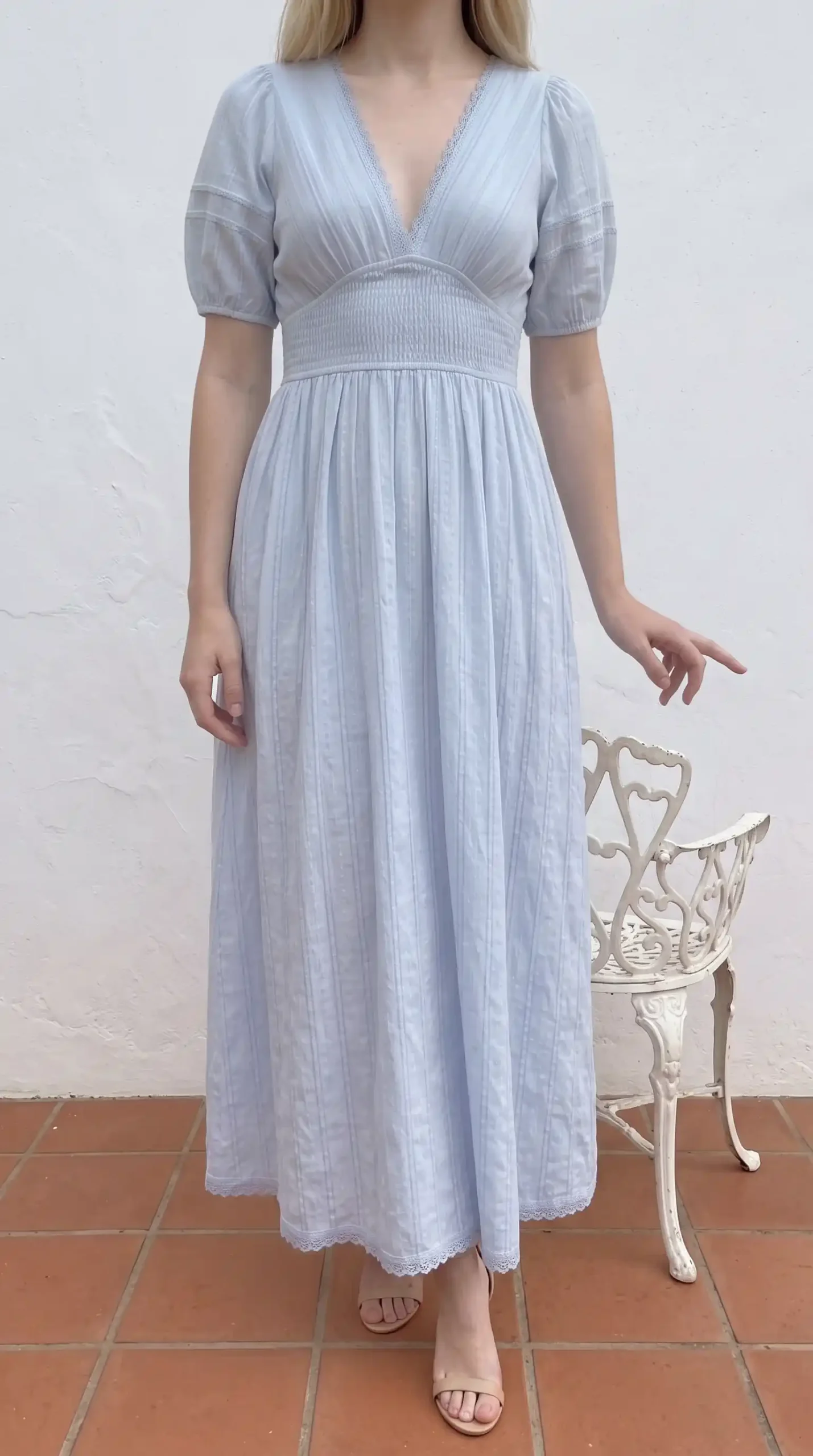 Woman wearing ice blue cotton deep V-neck lace trim puff sleeve smocked waist maxi dress