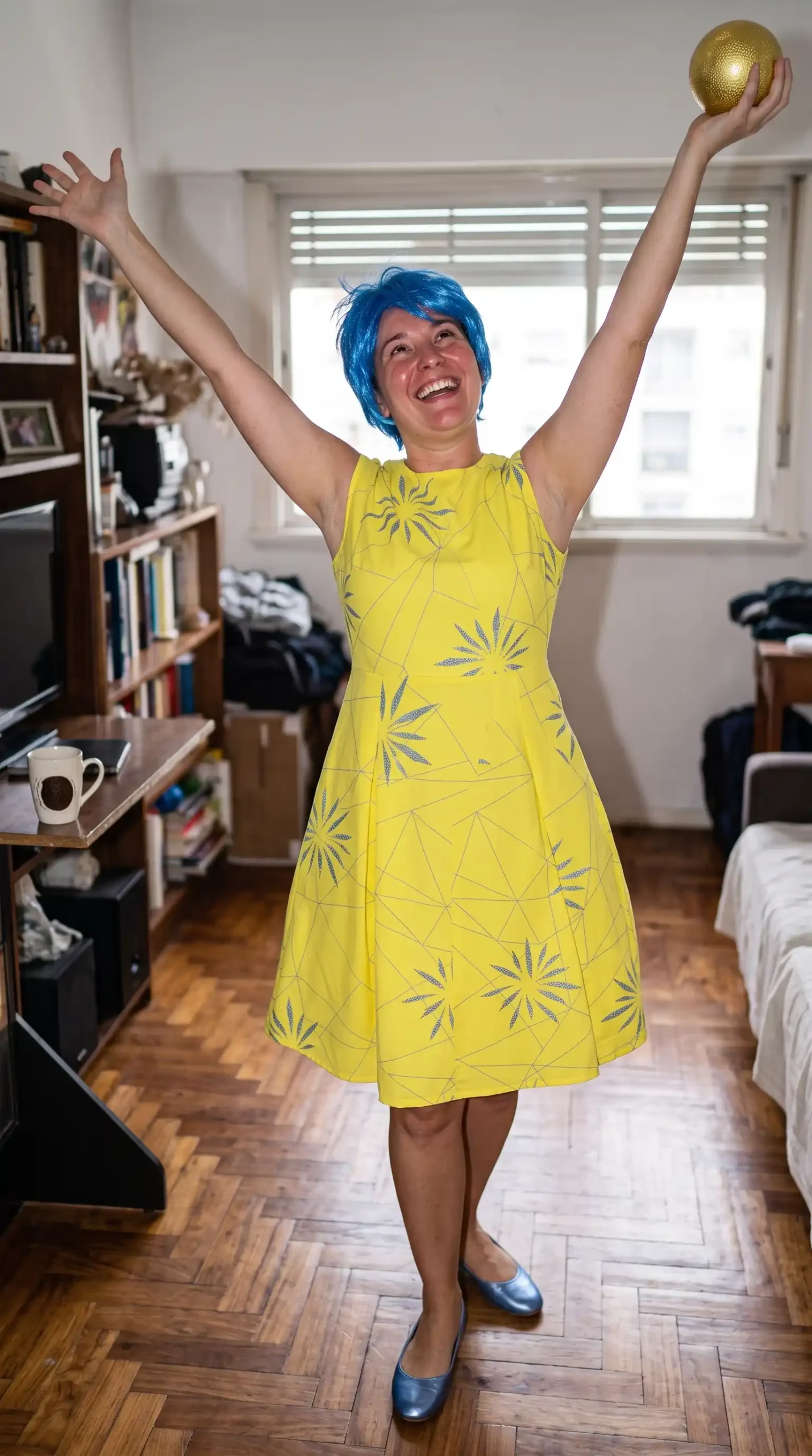 Woman as Joy from Inside Out in yellow starburst dress with blue pixie wig