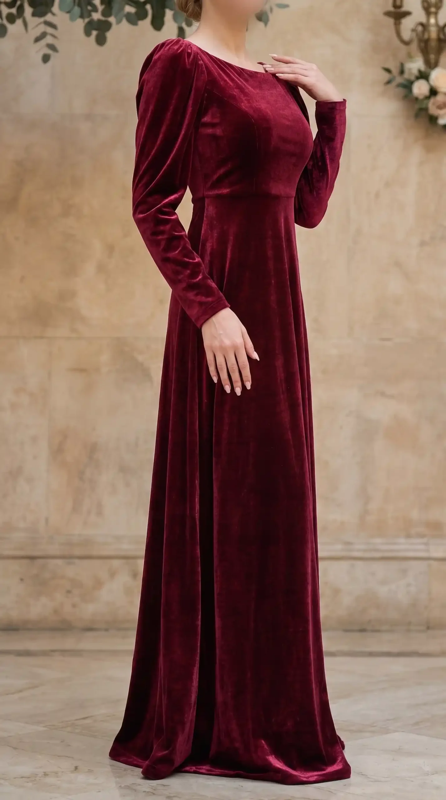 Woman wearing cranberry red velvet long sleeve scoop neck A line maxi dress at wedding venue