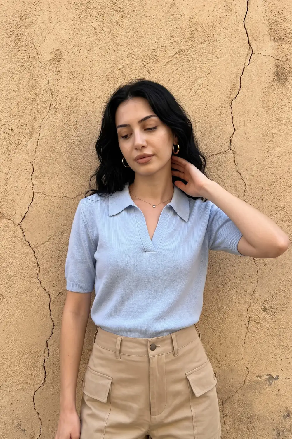 Woman in baby blue short sleeve open collar knit polo with beige cargo trousers