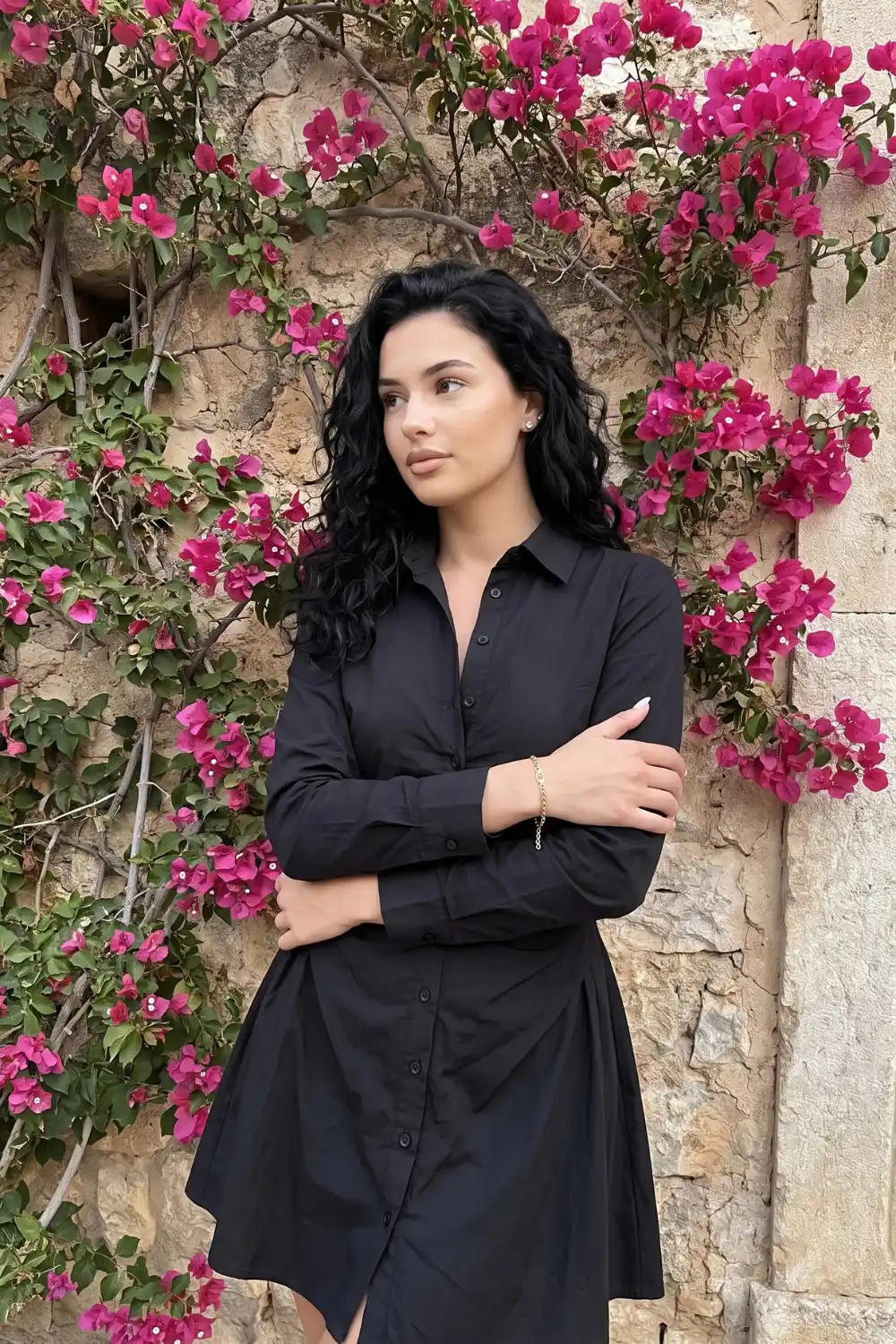 Woman wearing black cotton long sleeve flared mini shirt dress