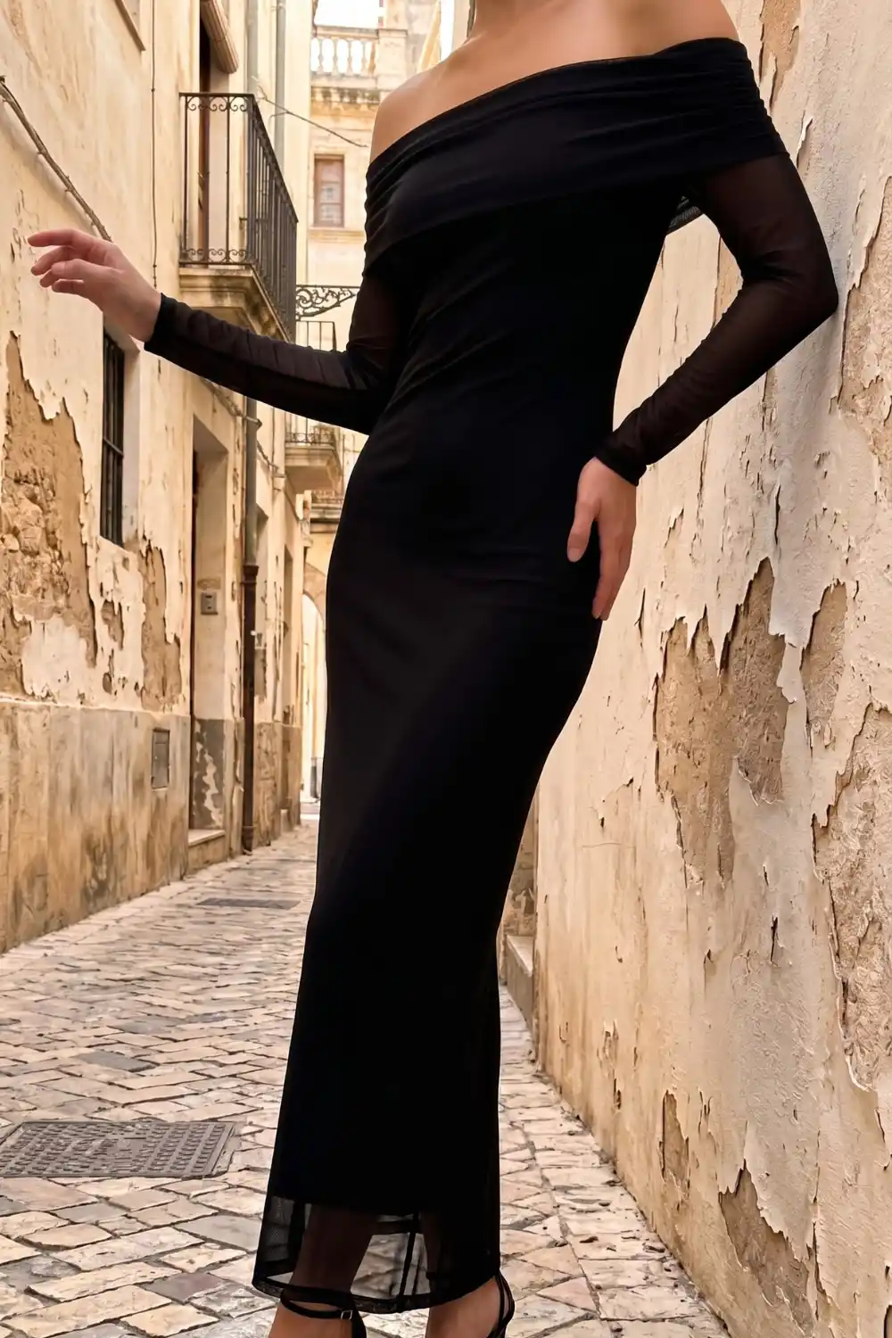 Woman wearing black mesh off shoulder long sleeve maxi dress