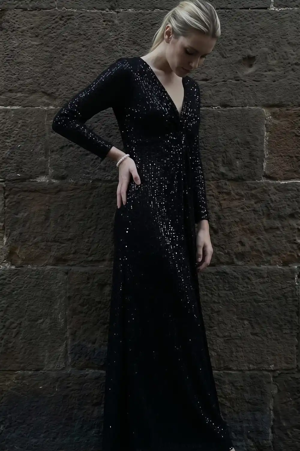 Woman wearing black sequin long sleeve maxi dress