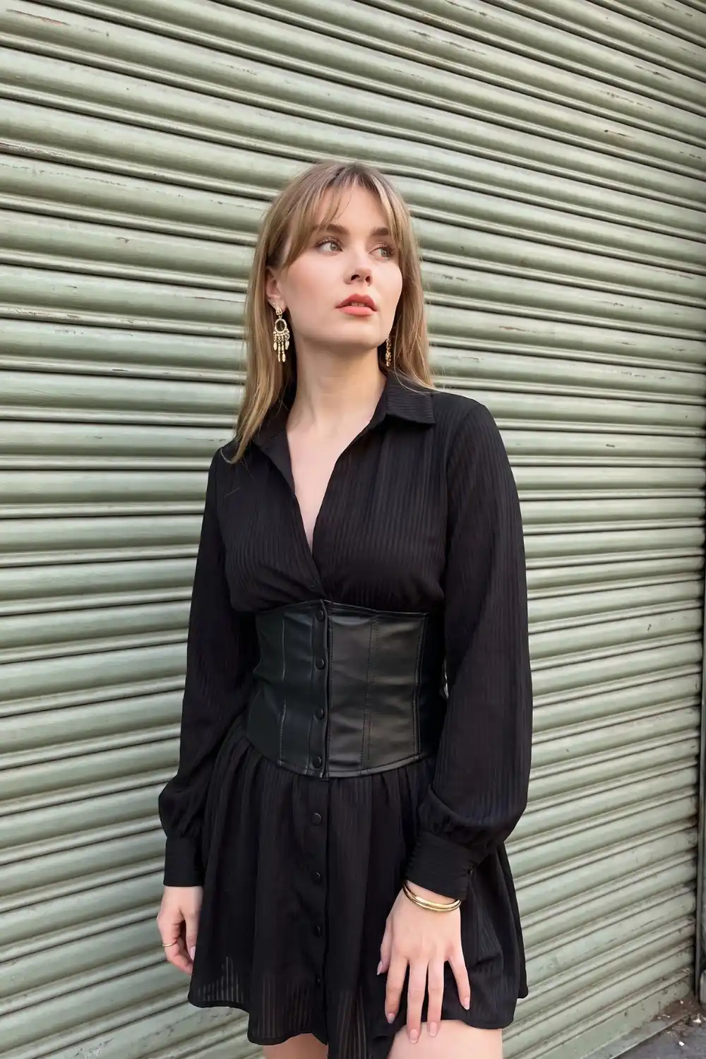 Woman wearing black tonal stripe chiffon mini shirt dress with faux leather corset belt