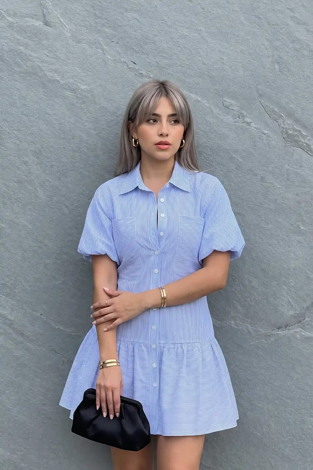 Woman wearing blue white pinstripe puff sleeve tiered mini shirt dress
