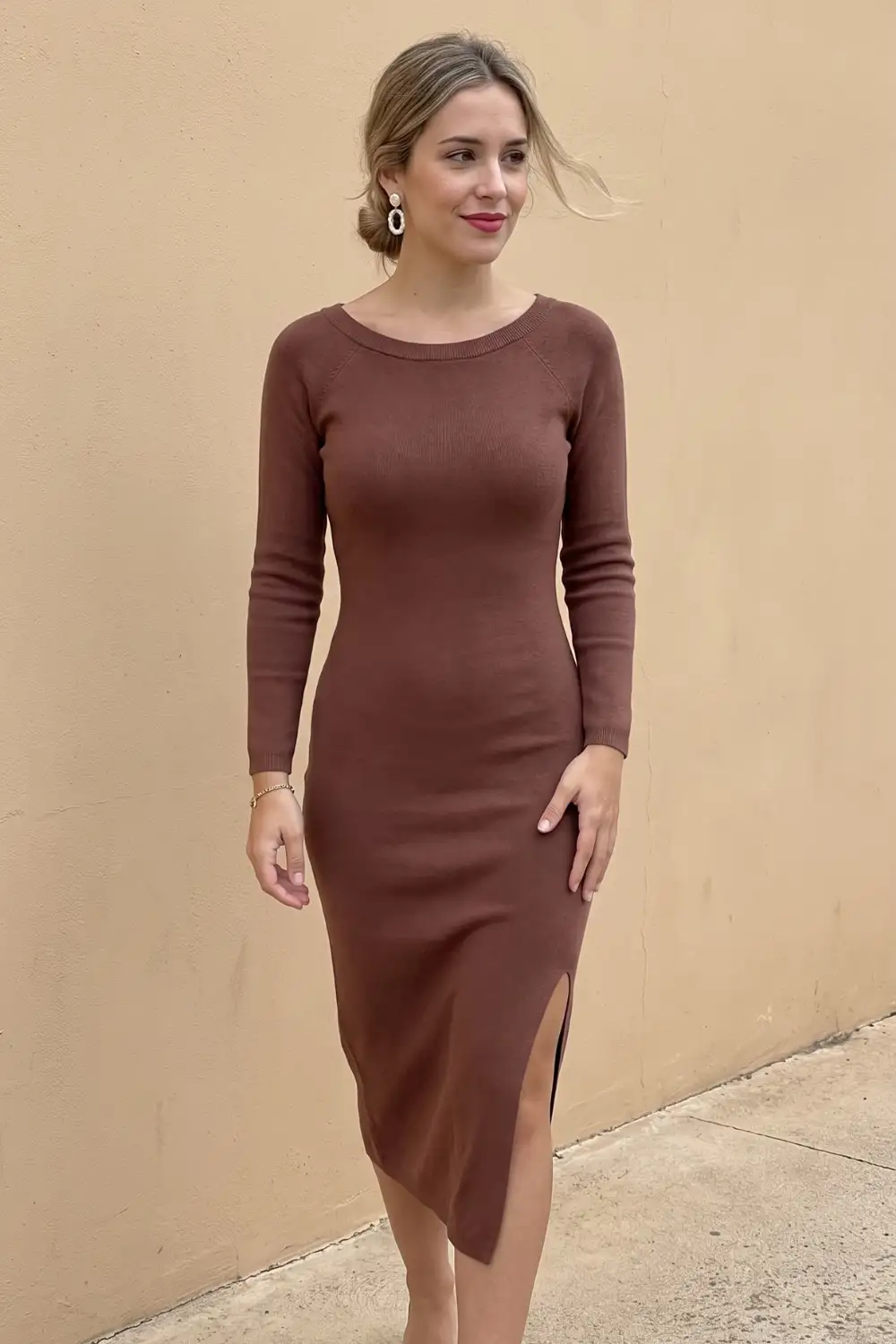 Woman in chocolate brown crew neck fitted knit midi sweater dress with side slit