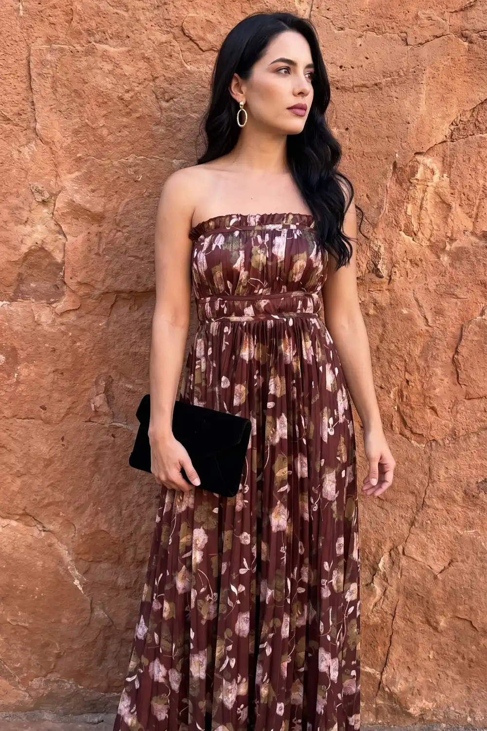 Woman wearing brown floral strapless pleated maxi dress