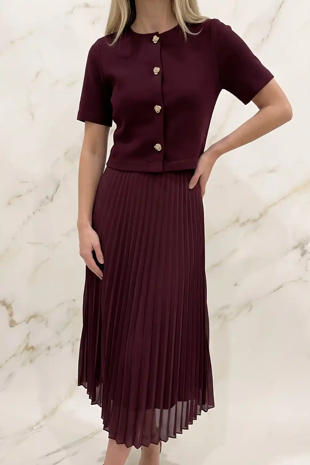 Woman wearing burgundy pleated midi skirt co-ord set