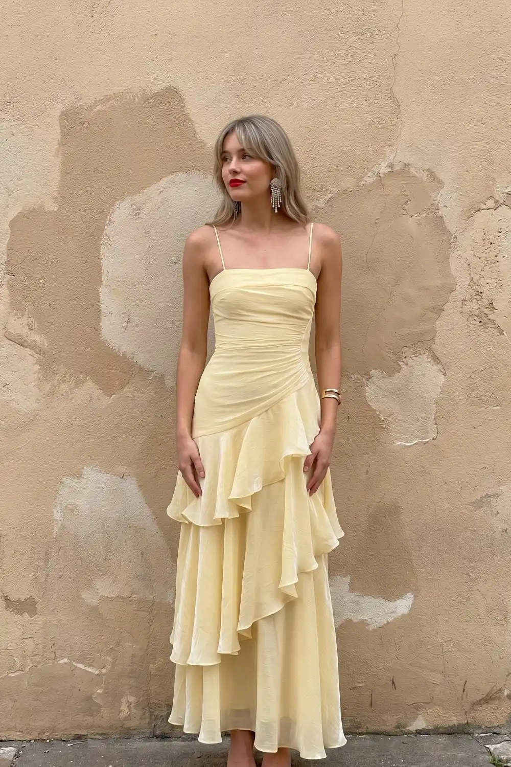 Woman in butter yellow ruched spaghetti strap maxi dress