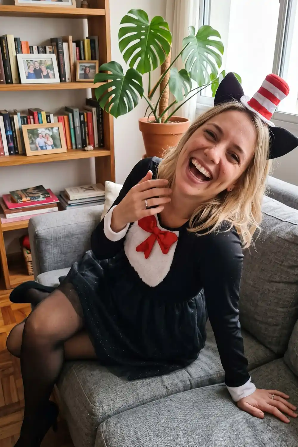 Woman dressed as Cat in the Hat in black velvet dress with striped hat headband