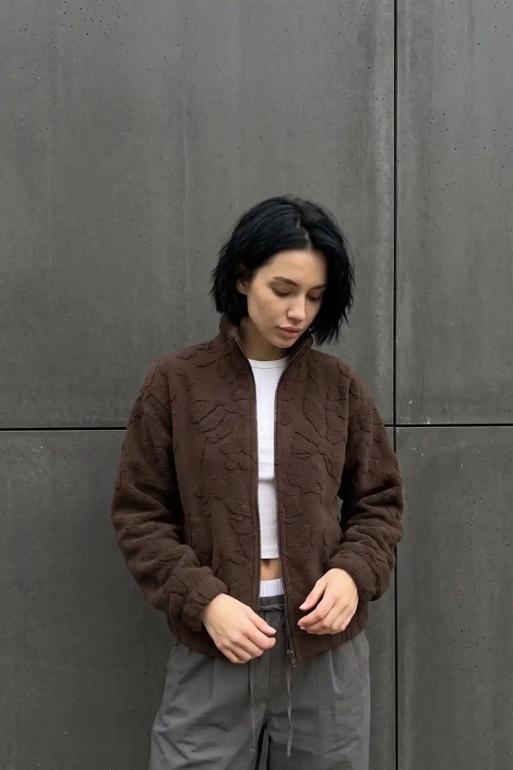 Woman wearing dark chocolate brown floral textured sherpa zip bomber jacket