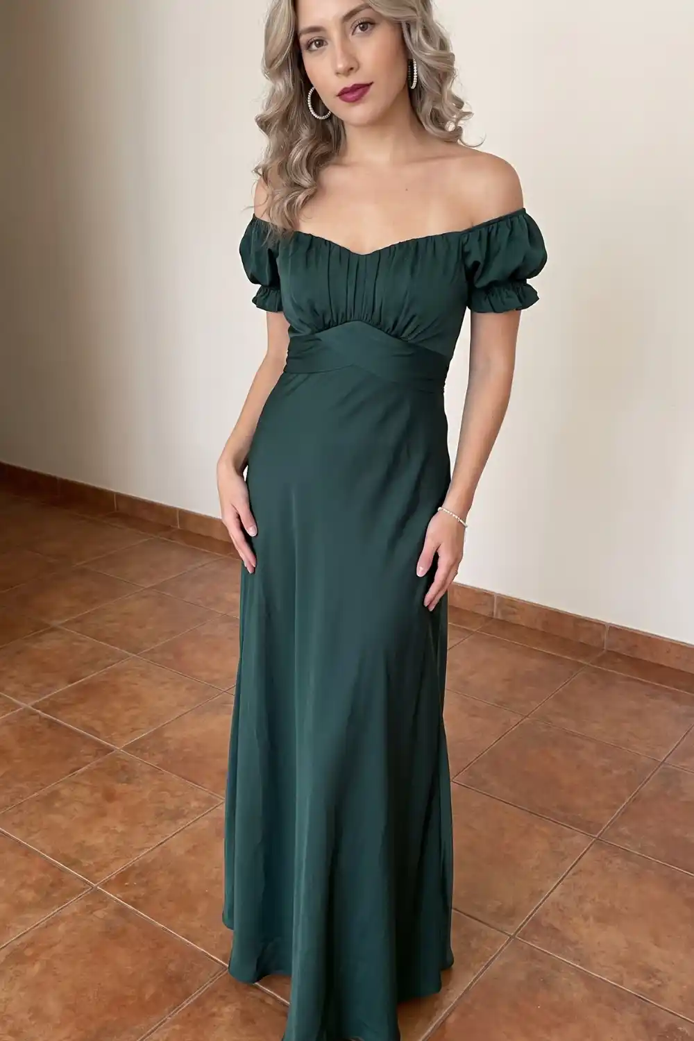 Woman in emerald green off shoulder sweetheart maxi dress