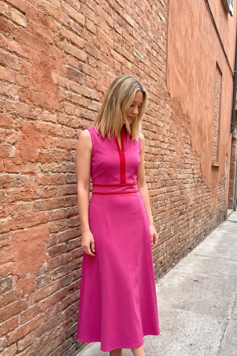 Woman wearing fuchsia and red color block sleeveless midi dress