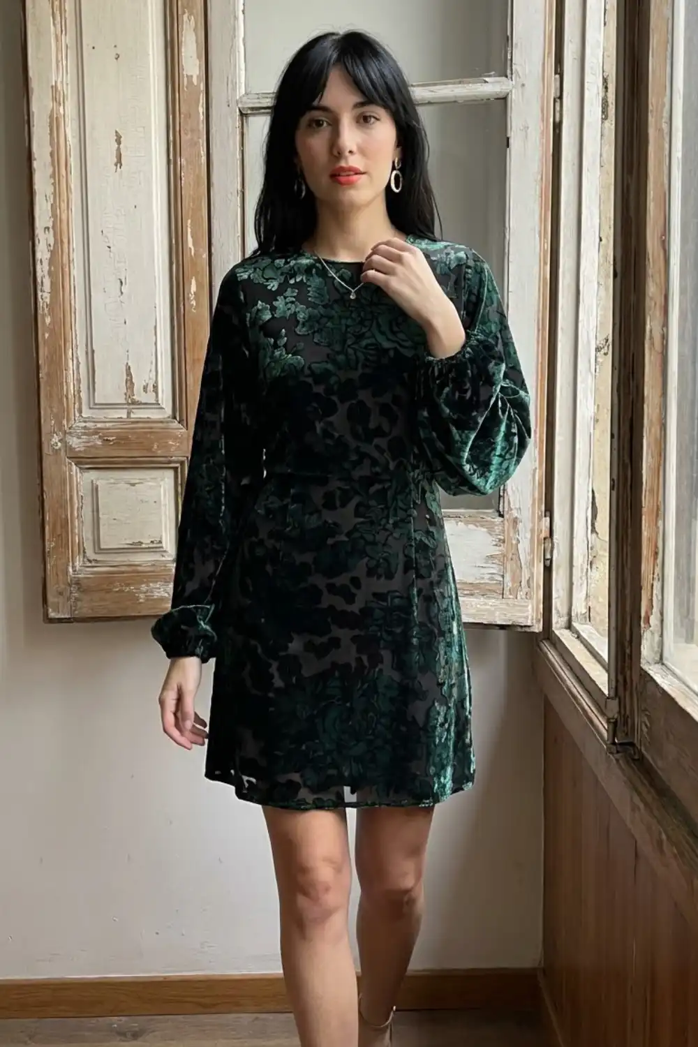 Woman in dark green floral burnout velvet long sleeve mini dress