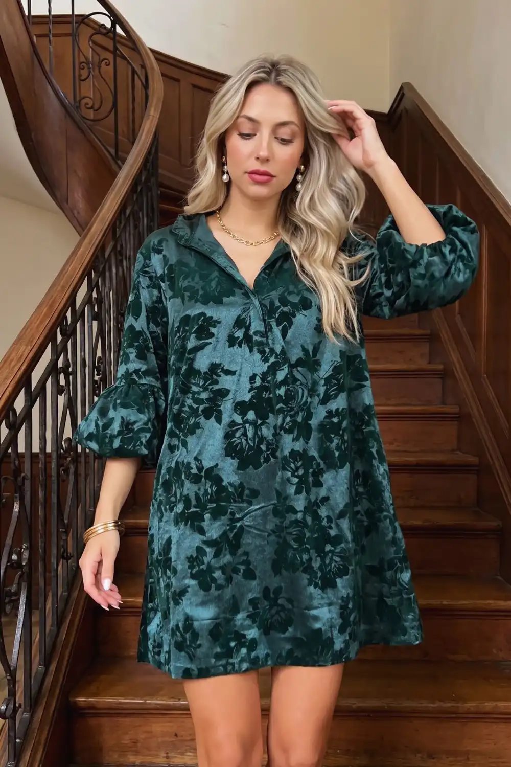 Woman in teal green floral jacquard velvet collared puff sleeve swing mini dress