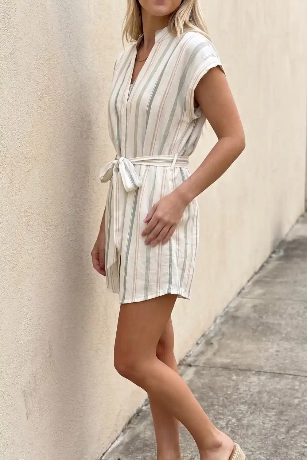 Woman wearing cream and sage striped belted linen mini shirt dress