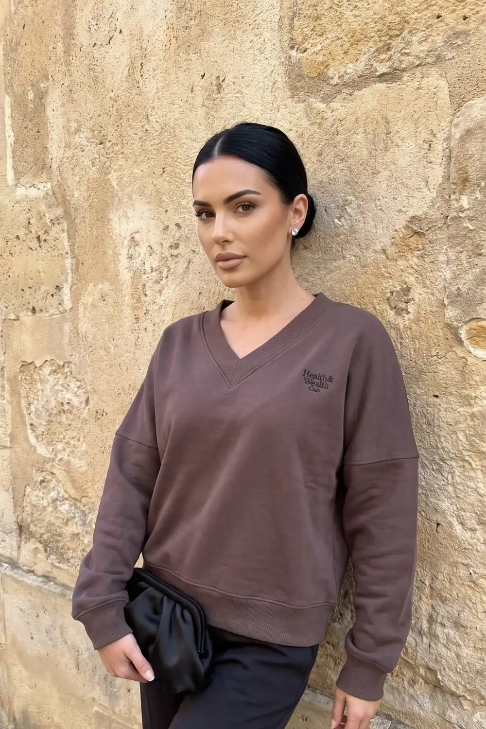 Woman wearing mocha brown v-neck oversized sweatshirt