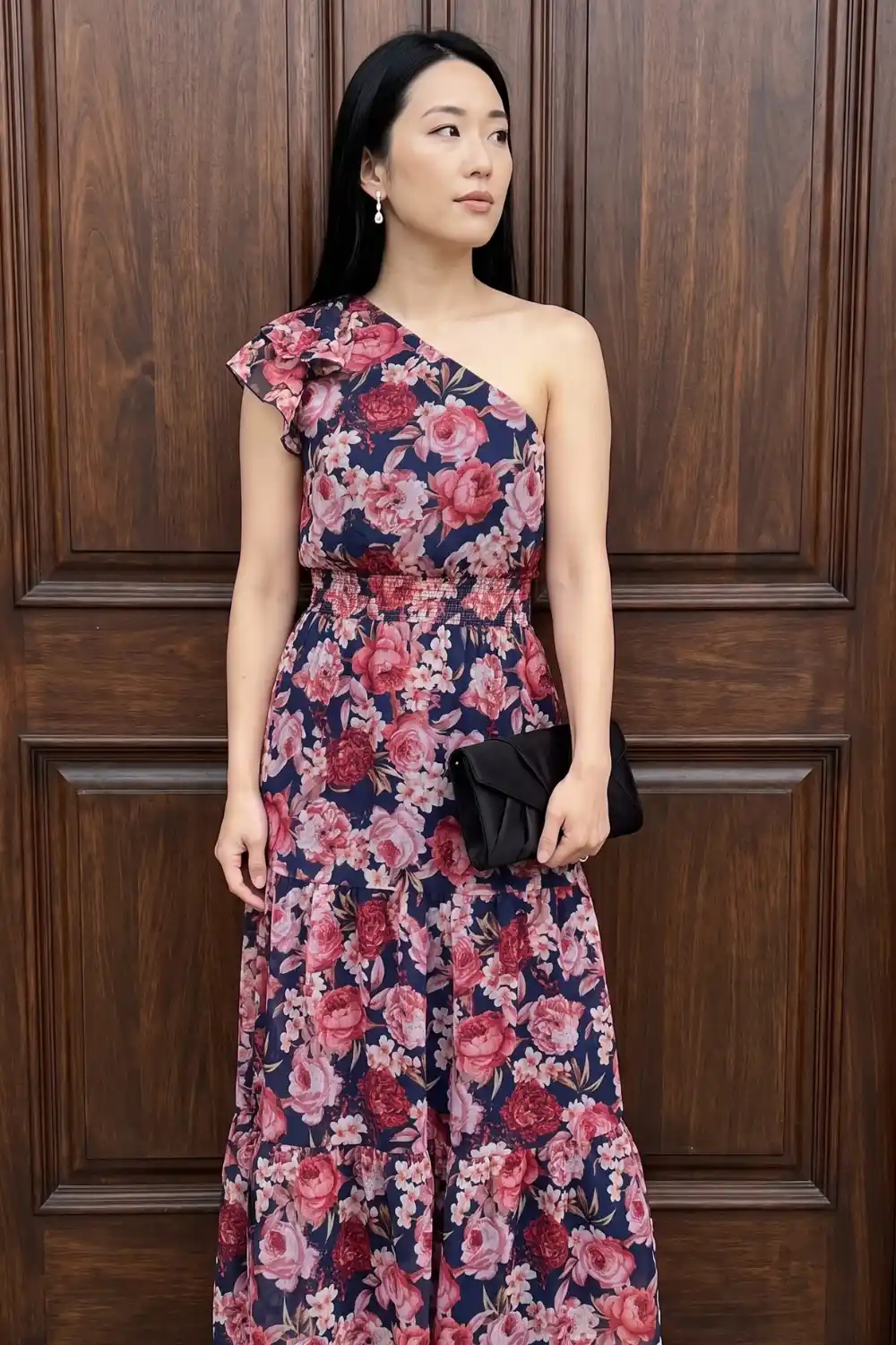 Woman wearing navy blue floral one shoulder maxi dress