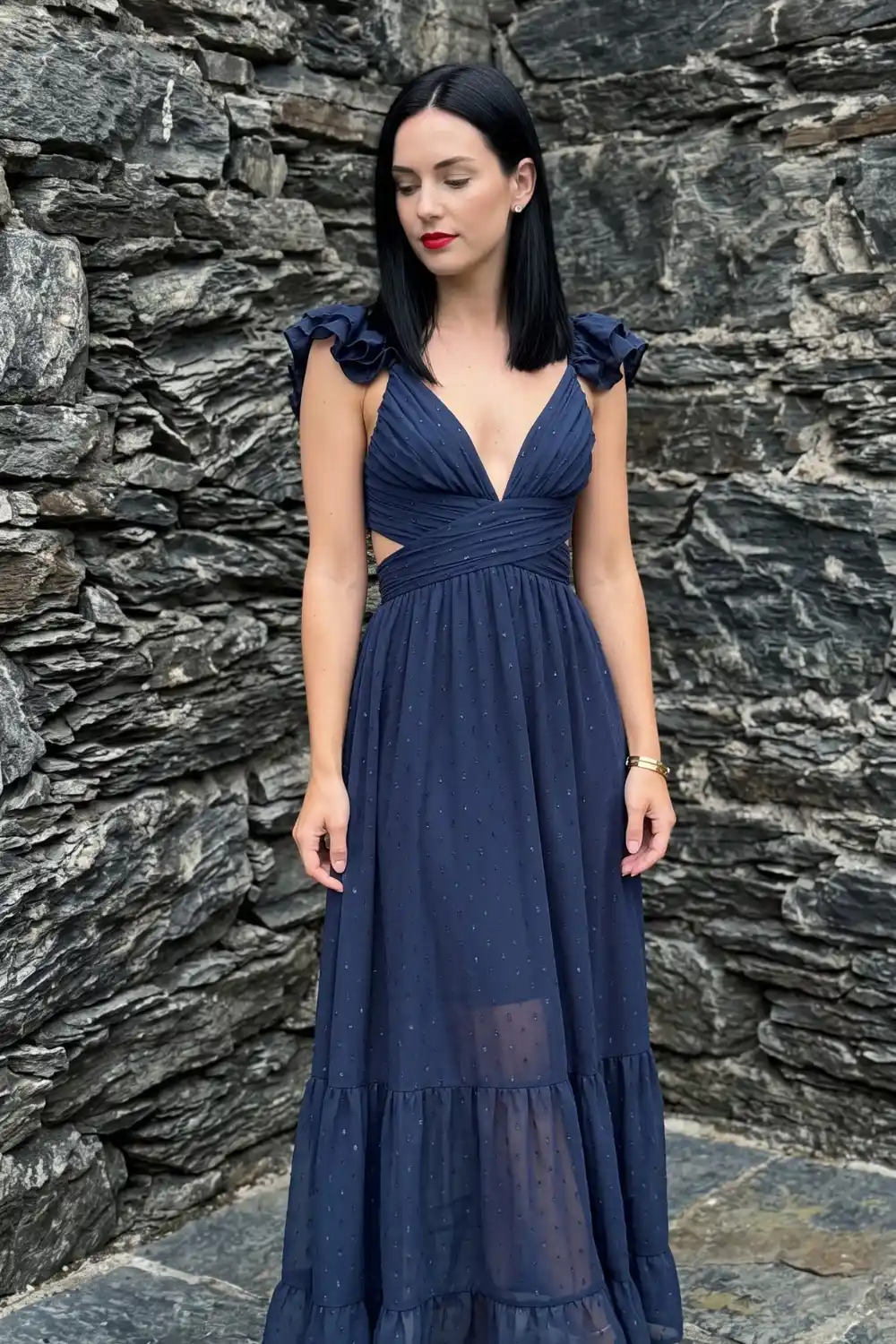 Woman in navy glitter tulle deep v-neck tiered maxi dress