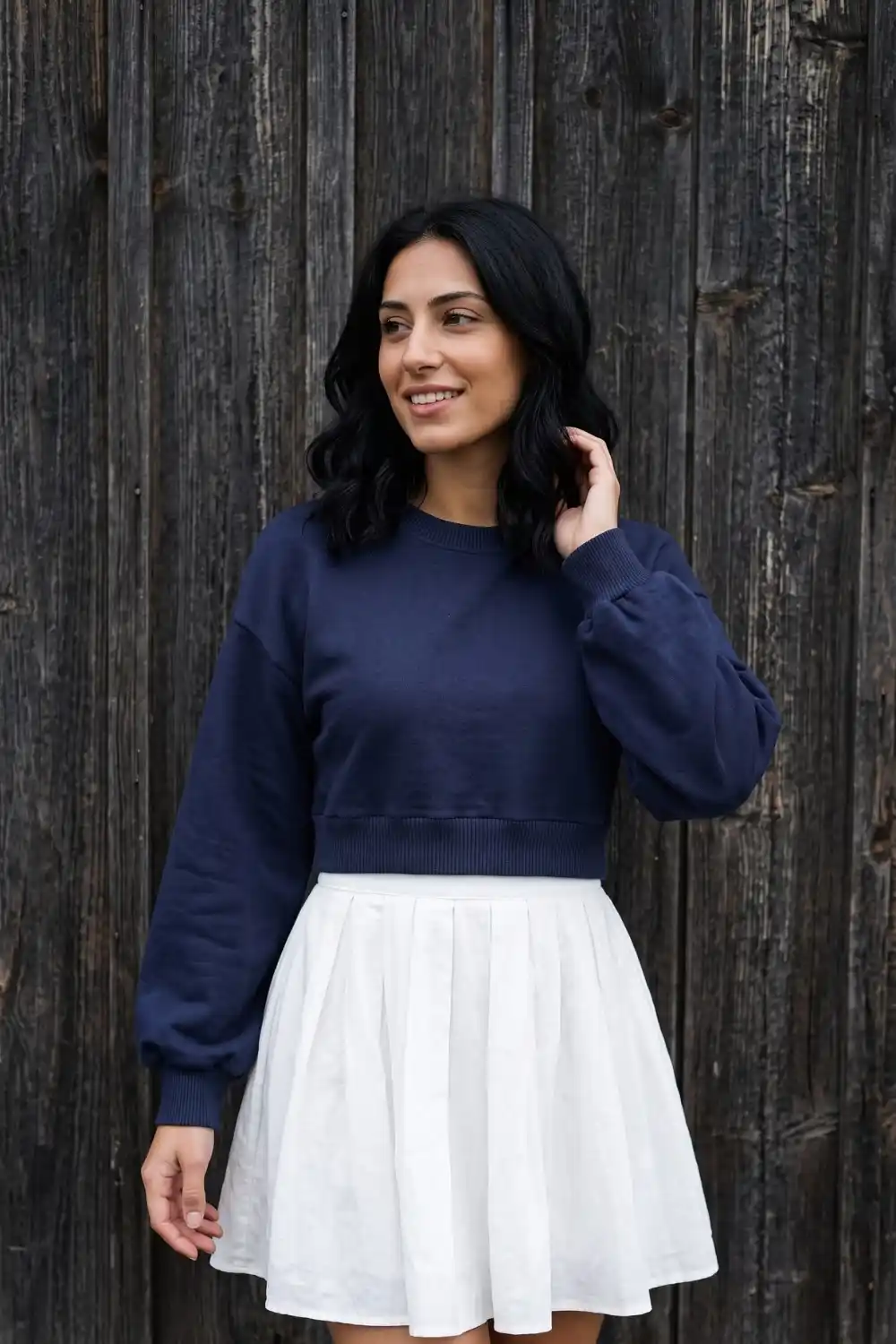 Woman wearing navy oversized crop crew neck sweatshirt