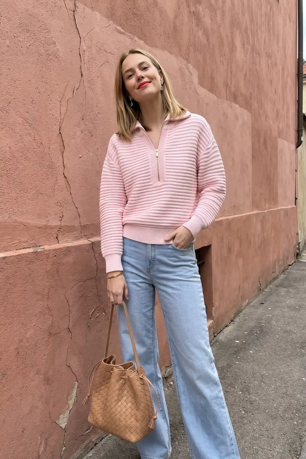 Woman in pink ribbed half-zip sweater with light wash wide leg jeans