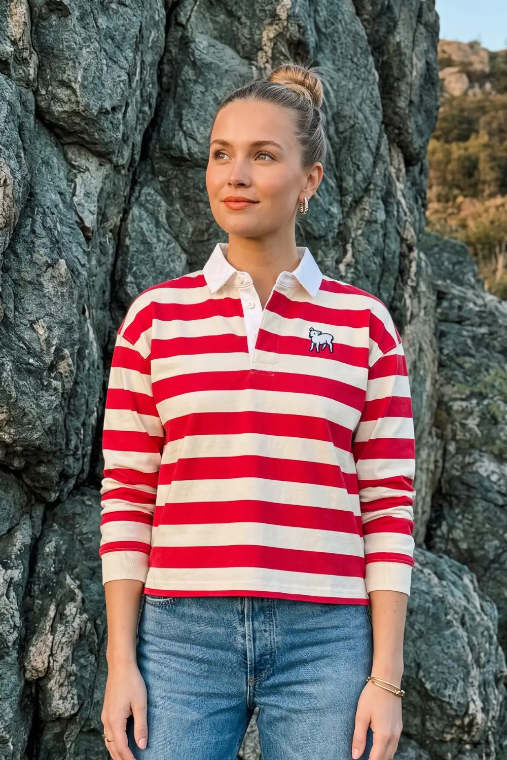 Woman in red white stripe cropped rugby polo with blue jeans