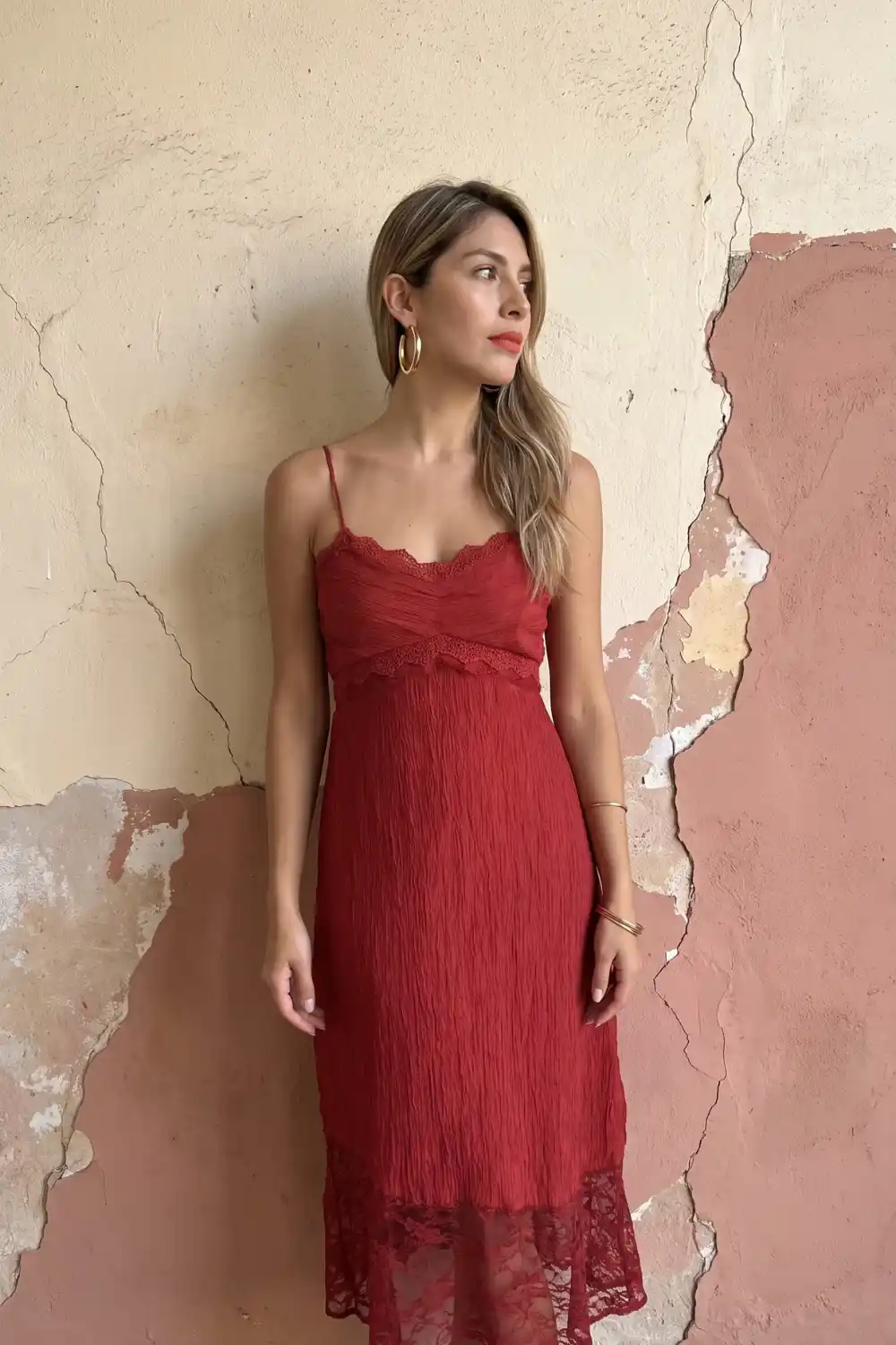 Woman wearing rust red crinkle chiffon lace trim slip midi dress