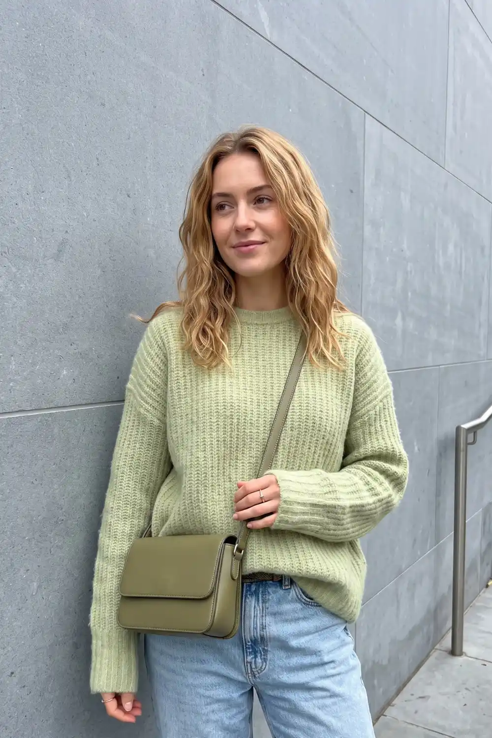 Woman wearing sage green chunky ribbed crew neck knit sweater