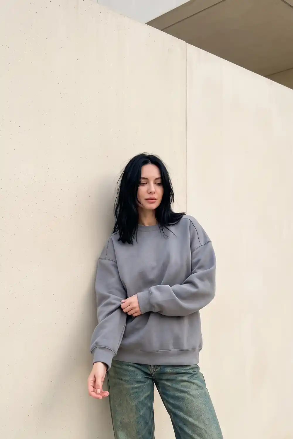 Woman wearing stone grey oversized crew neck sweatshirt