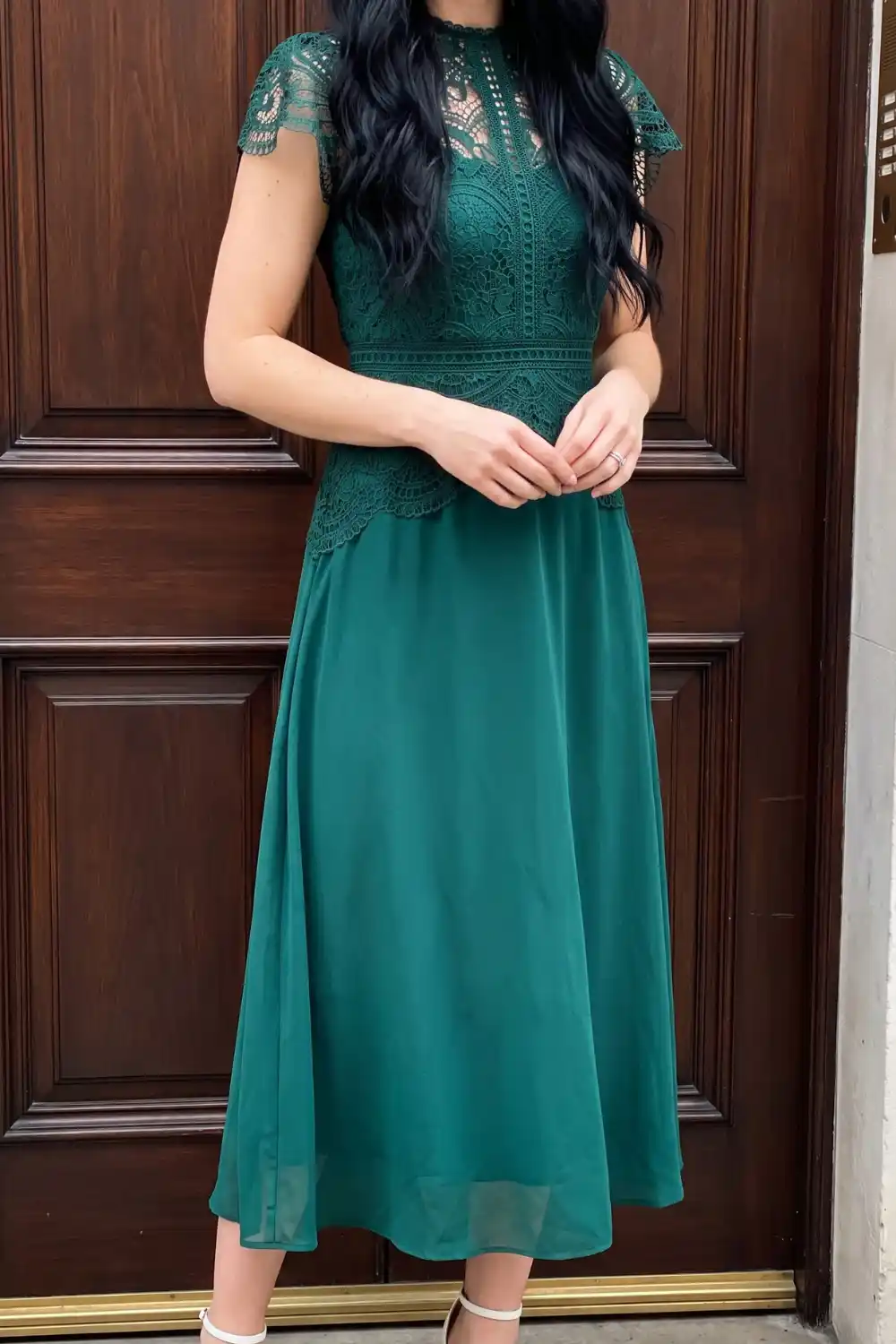 Woman wearing teal lace bodice mock neck chiffon midi dress