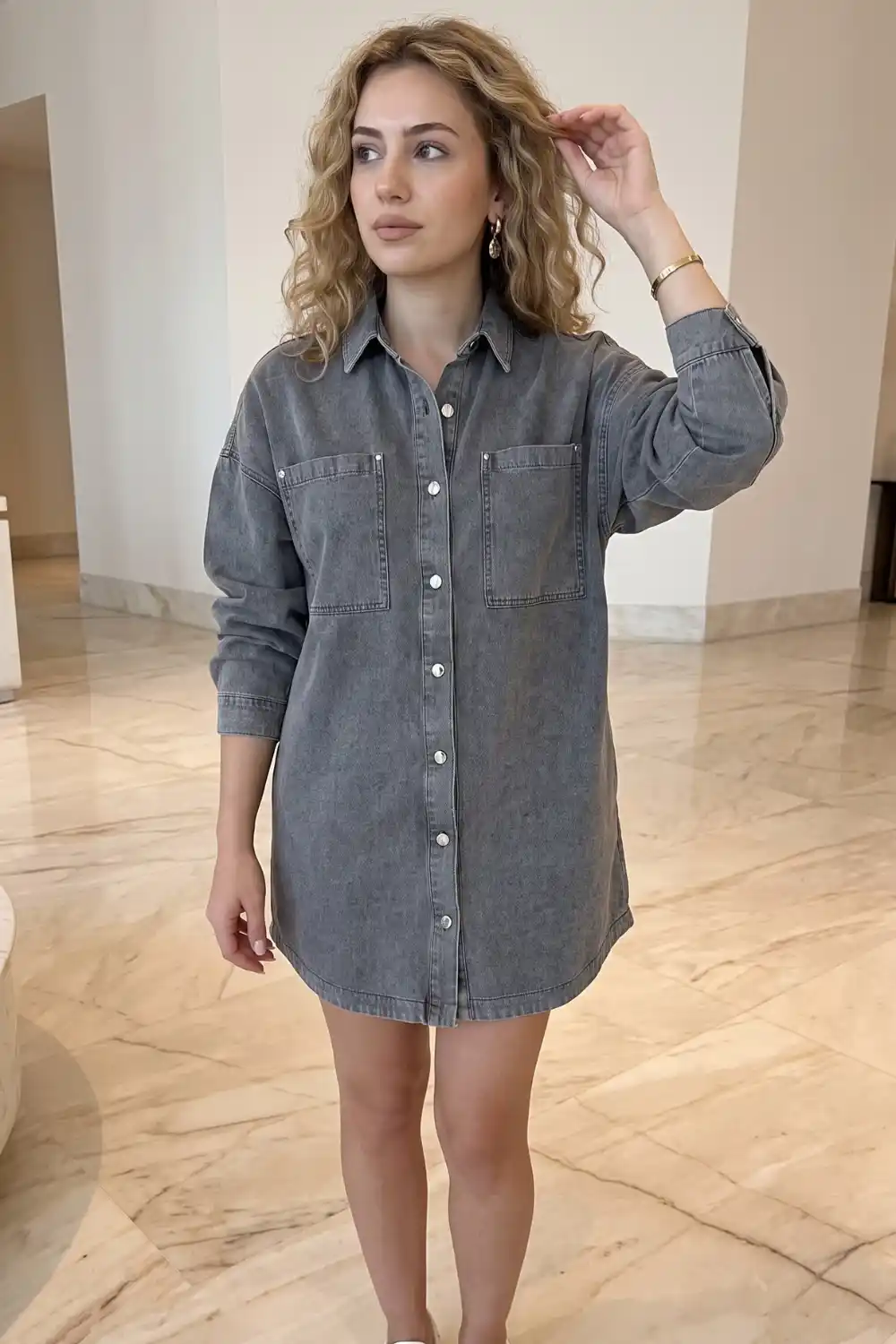 Woman wearing washed grey oversized denim mini shirt dress