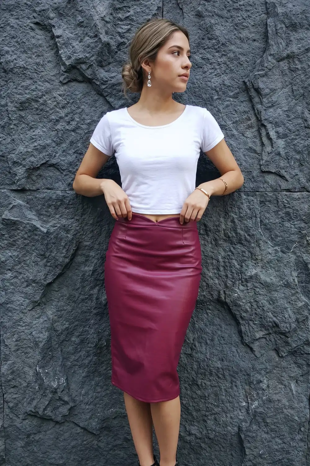 Woman in white crop tee with burgundy faux leather midi pencil skirt