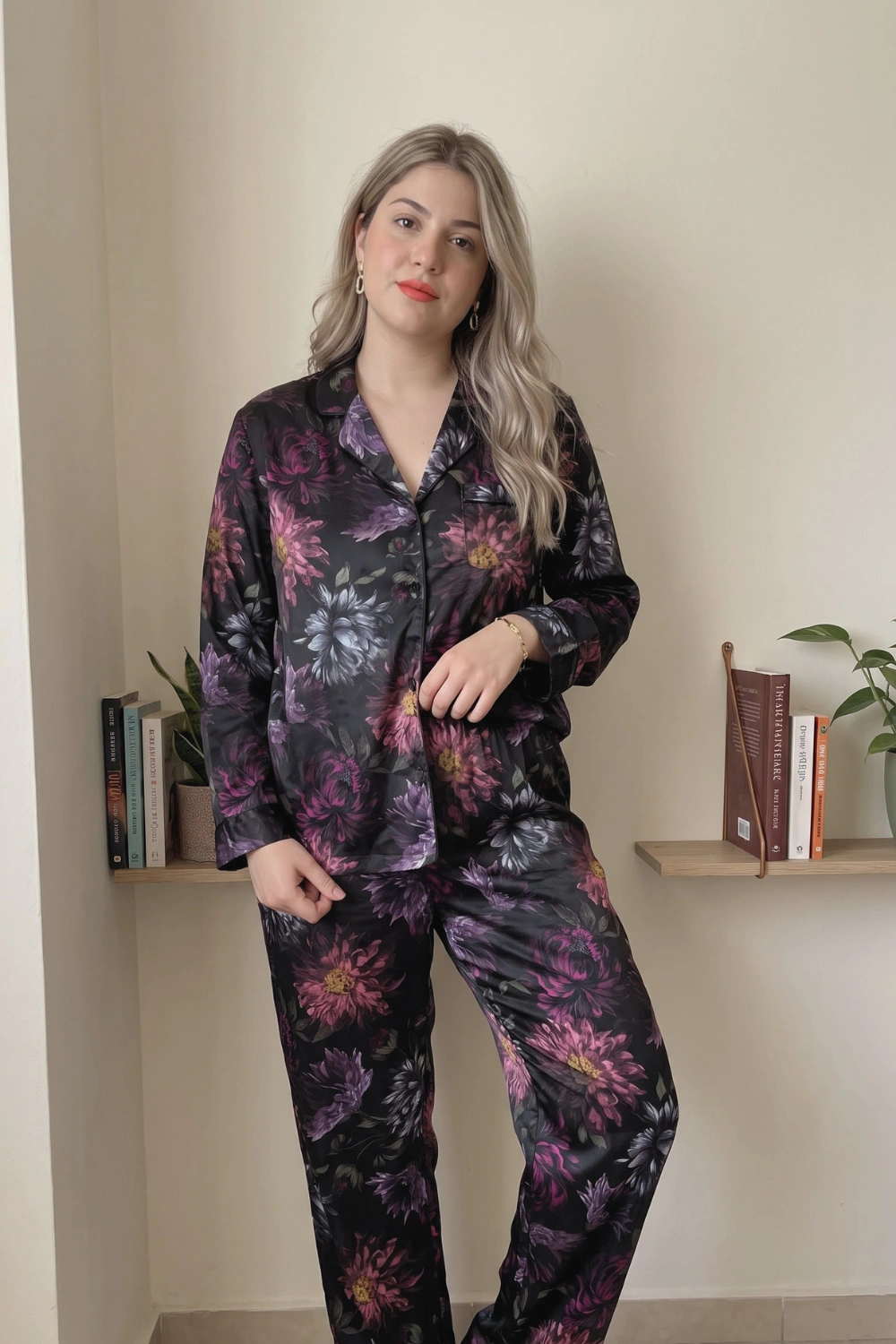Woman in black dark floral print satin long sleeve button down shirt and wide leg pants pajama set