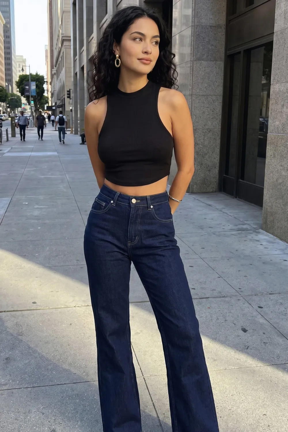 Woman in black halter neck crop top with dark navy high waist wide leg jeans
