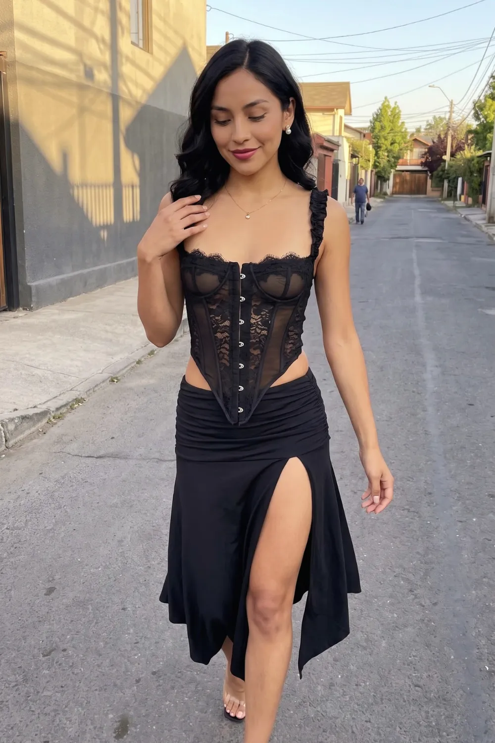 Woman in black sheer lace corset top with black ruched slit midi skirt