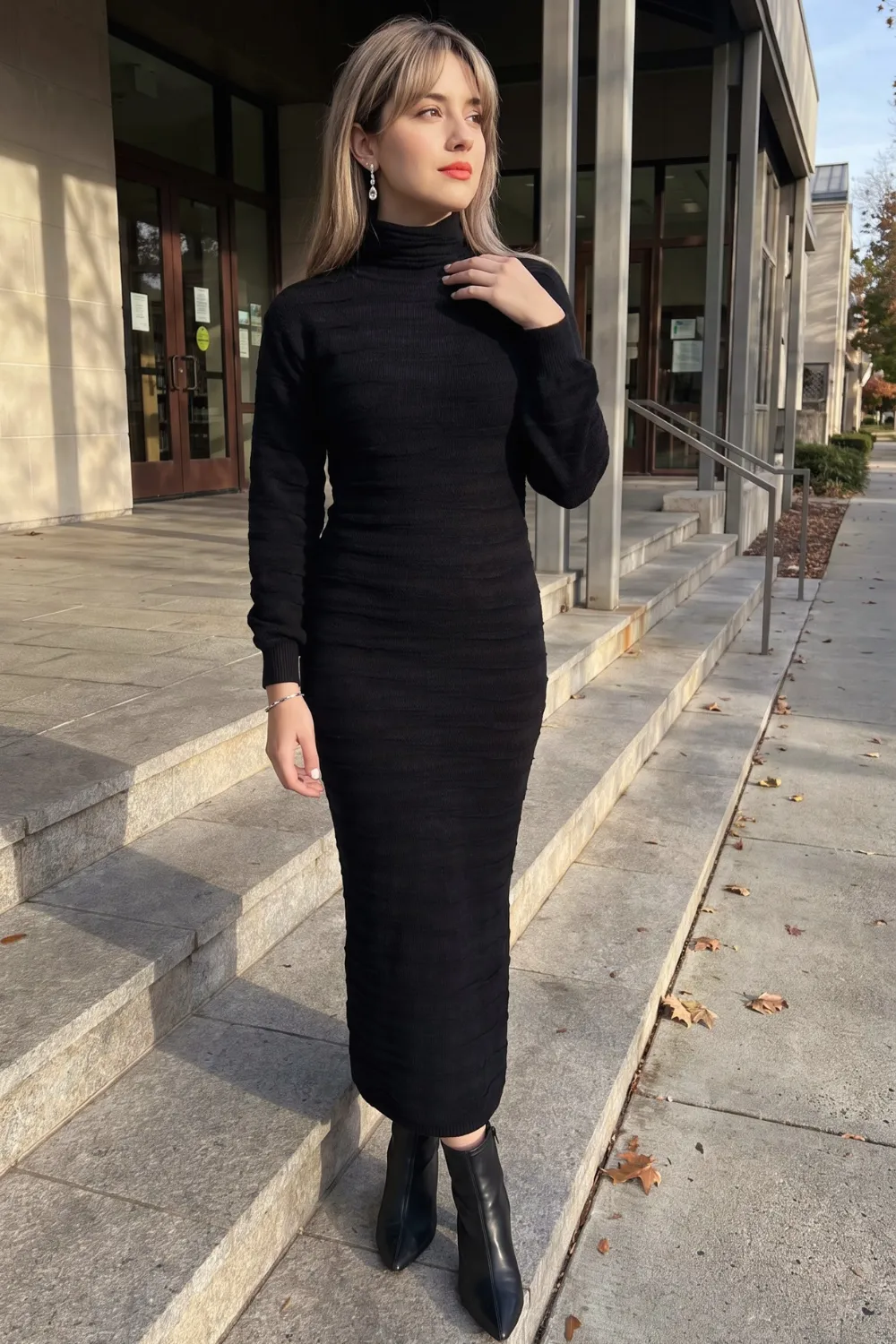 Woman in black ribbed turtleneck bodycon maxi dress with black ankle boots