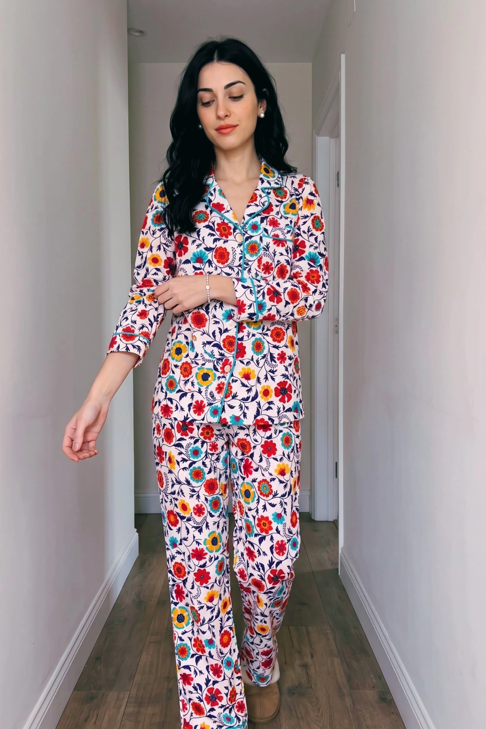 Woman in white multicolour bright floral print 3/4 sleeve button down shirt and wide leg pants pajama set