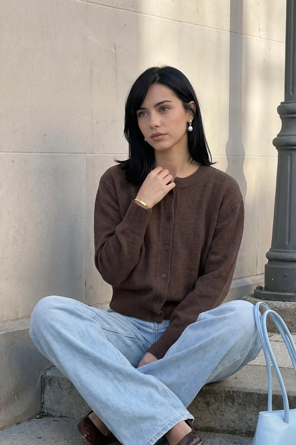 Woman in brown knit cardigan with light wash wide leg jeans