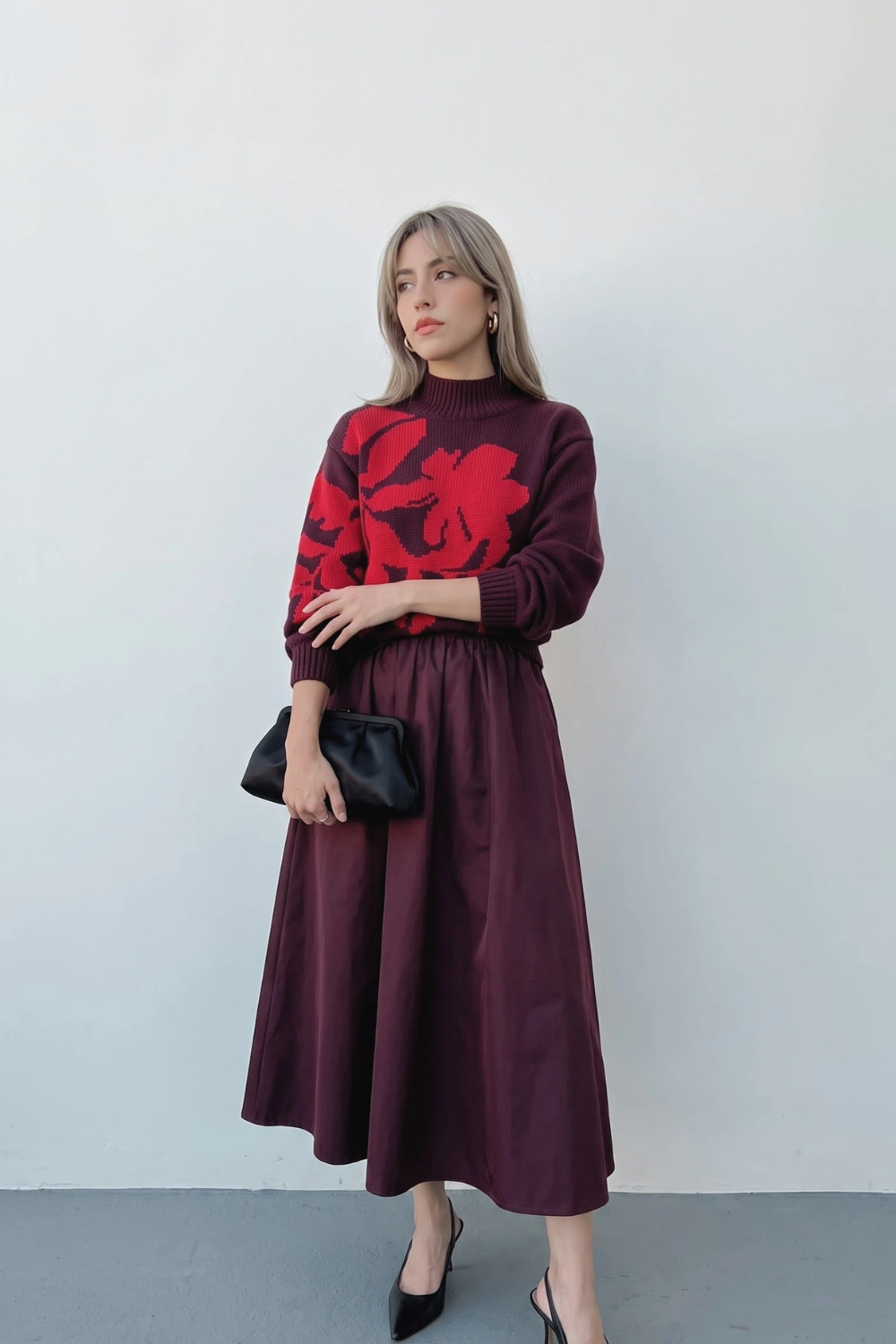 Woman in burgundy and red floral knit sweater with burgundy gathered midi skirt